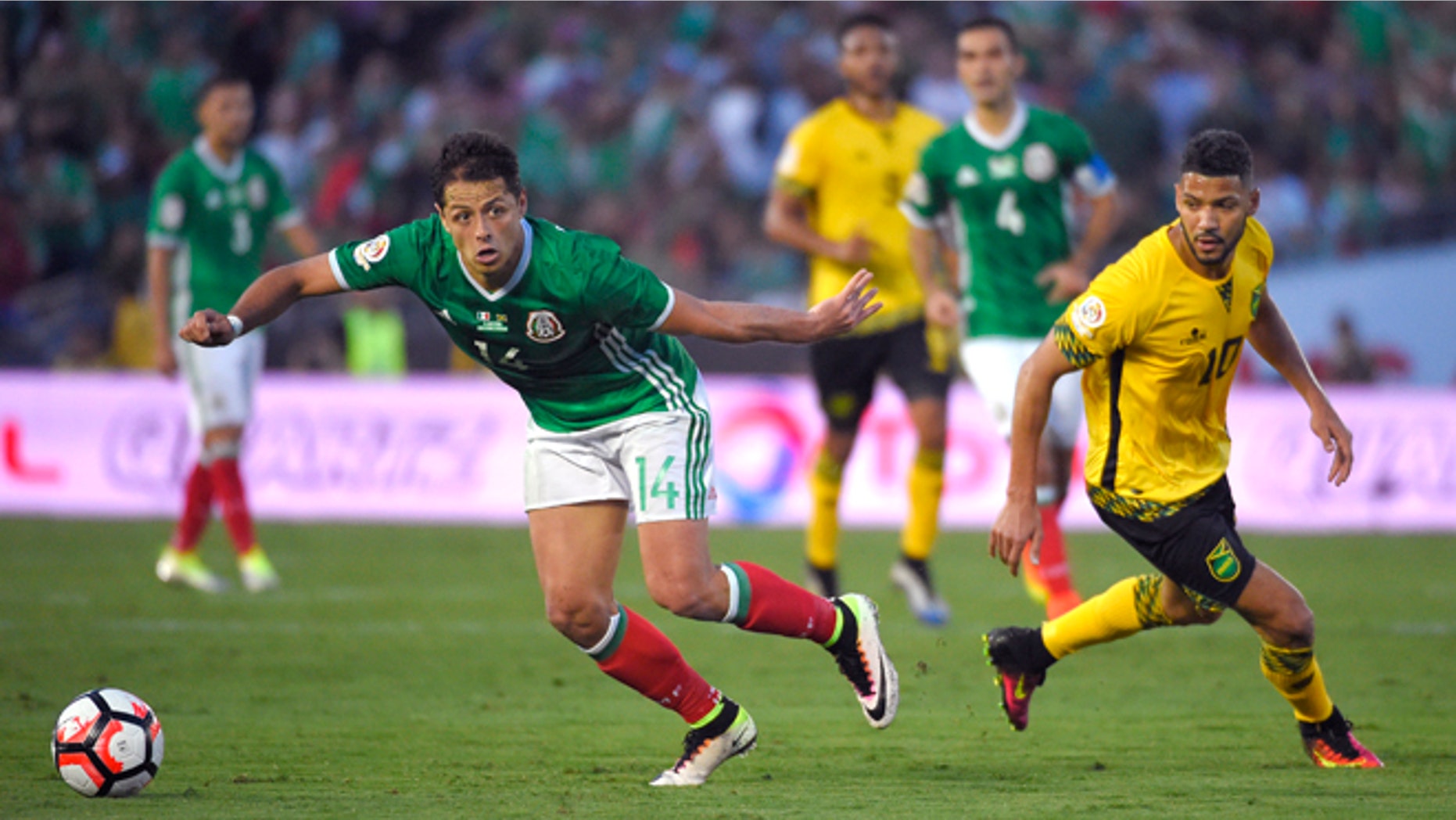 Mexico forward Chicharito, left, moves the ball as Jamaica midfielder Joel McAnuff pressures him during a Copa America group C soccer match at the Rose Bowl, Thursday, June 9, 2016, in Pasadena, Calif. (AP Photo/Mark J. Terrill)