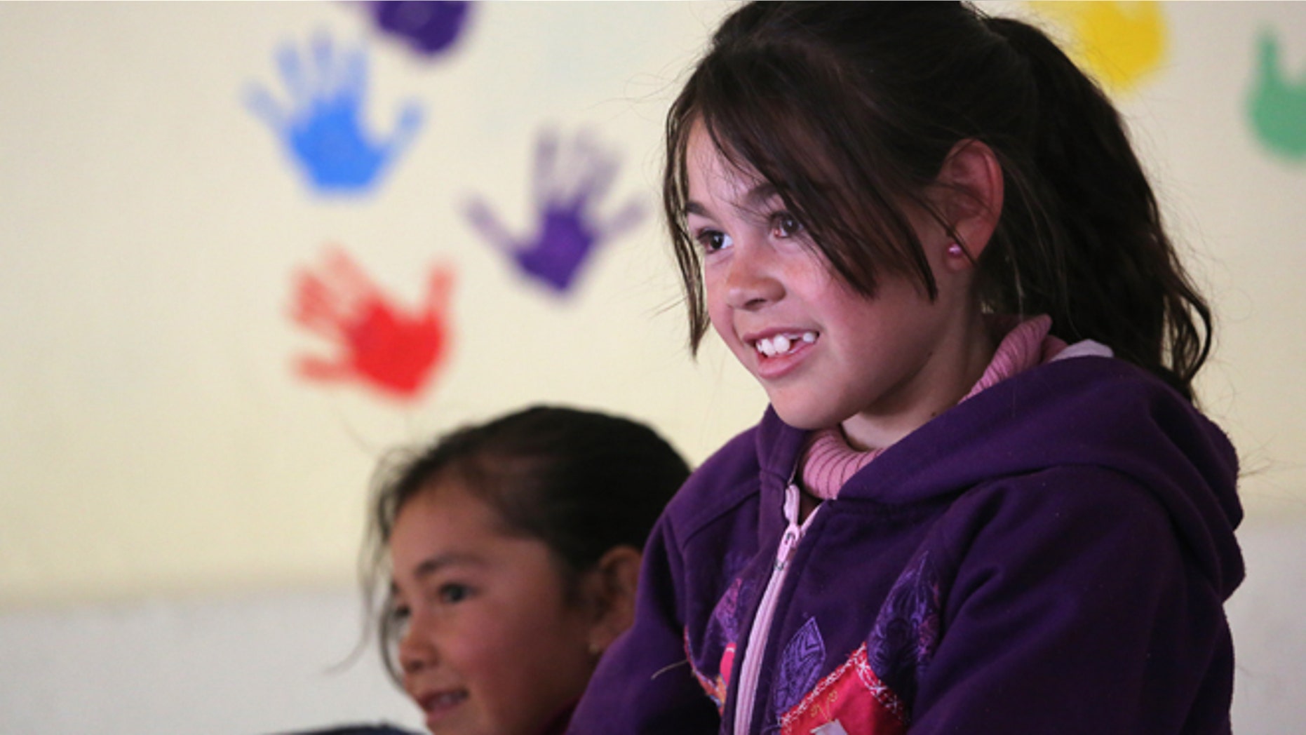 Children receive a free lunch at the Home of Hope and Peace kitchen on March 5, 2013 in Nogales, Mexico.