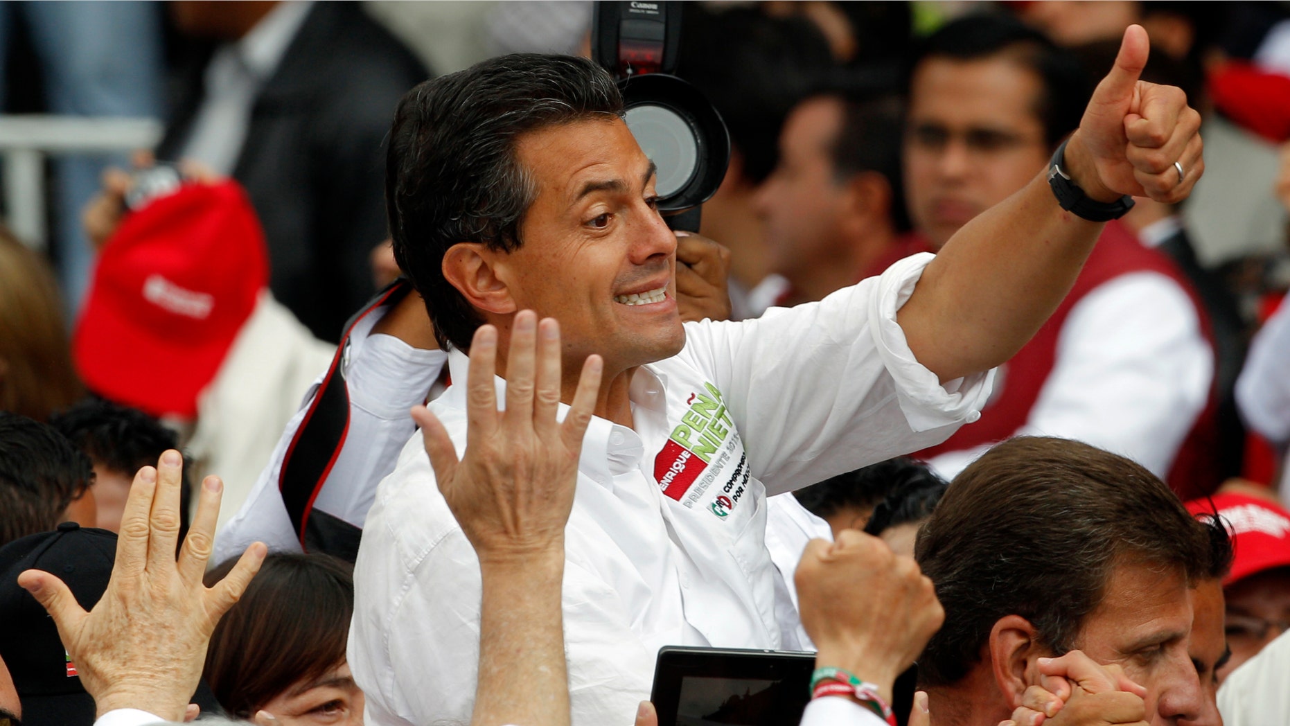 Presidential candidate Enrique Peña Nieto of the Institutional Revolutionary Party (PRI), flashes a thumbs up to supporters during his closing campaign rally in Toluca, Mexico, on Wednesday. (AP Photo/Andres Leighton)