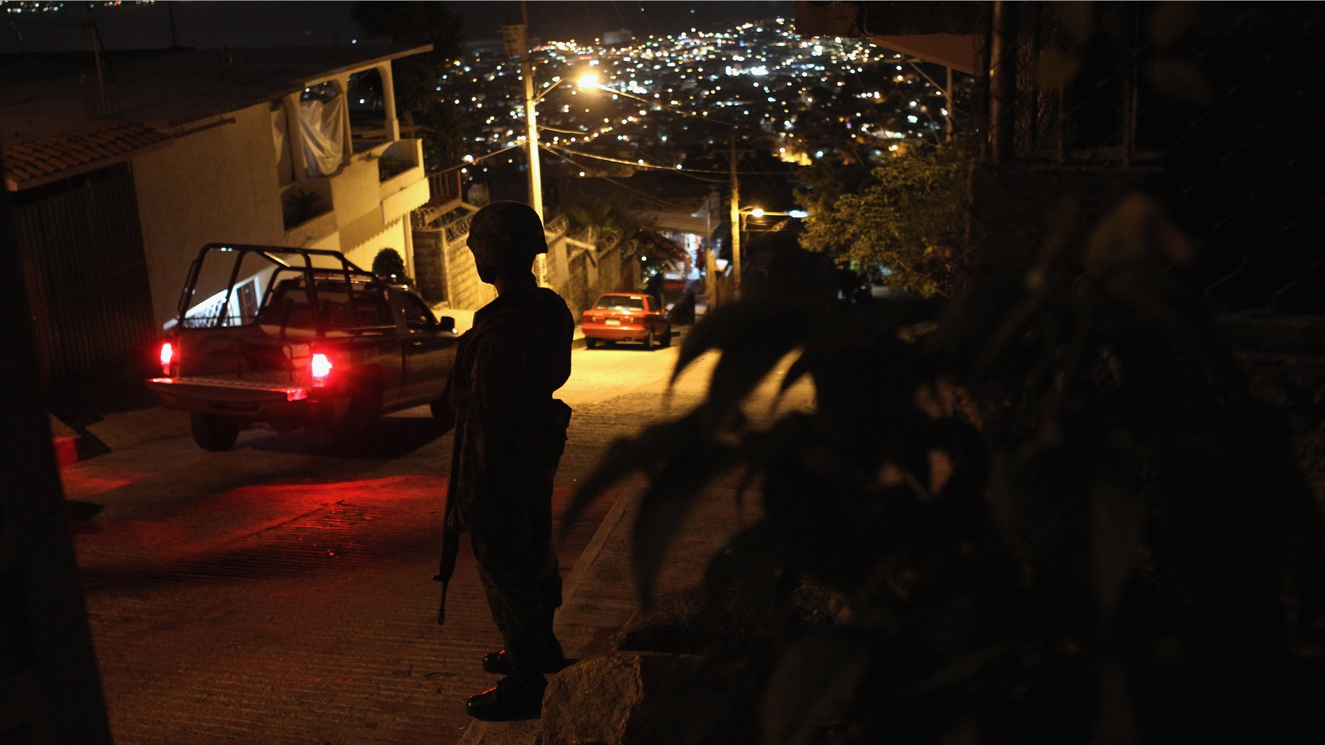 A Mexican army soldier stands guard at a suspected drug-related murder site March 3, 2012 in Acapulco, Mexico. (Photo by John Moore/Getty Images)