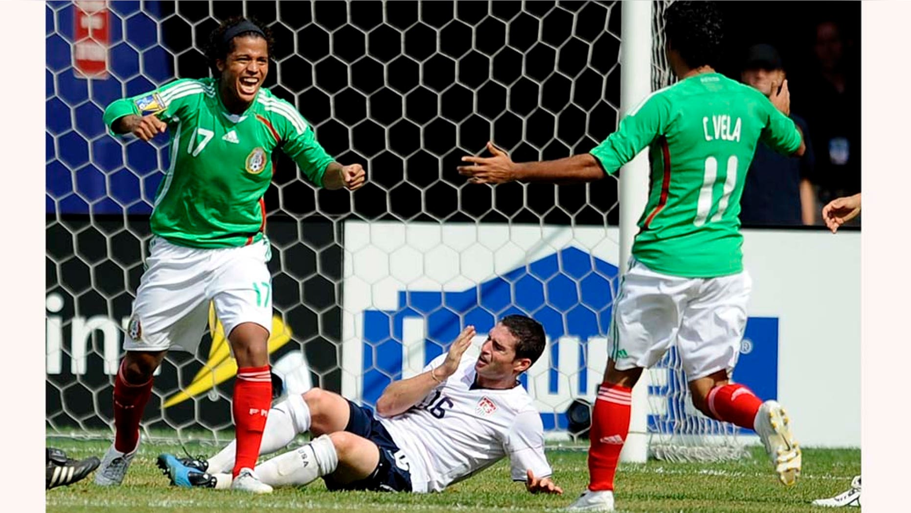 EAST RUTHERFORD, NJ - JULY 26: Giovani Dos Santos #17 and Carlos Vela #11 of Mexico celebrate Dos Santos' goal in front of Jay Heaps #16 of the United States in the CONCACAF Gold Cup Championship match at Giants Stadium on July 26, 2009 in East Rutherford, New Jersey. (Photo by Jeff Zelevansky/Getty Images)