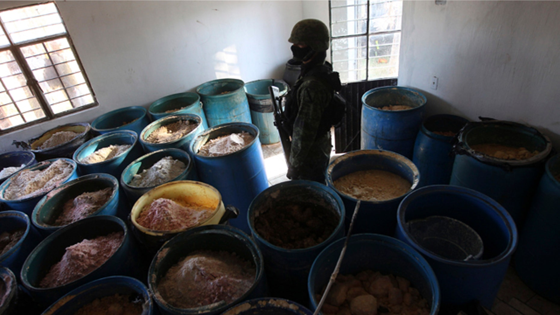 Feb. 9, 2012- A soldier stands in a room full of barrels containing white and yellow powder after a seizure of a small ranch in Tlajomulco de Zuniga, on the outskirts of Guadalajara, Mexico. According to the Mexican army, 15 tons of pure methamphetamine were seized at the ranch, an amount equivalent to half of all meth seizures worldwide in 2009.