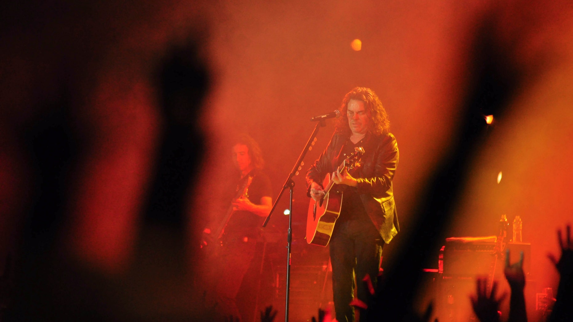 Lead singer Fher Olvera, of the Mexican rock band Mana, performs during "Concierto por la Paz" in Ciudad Juarez, Mexico, late Wednesday Oct. 12, 2011. Ciudad Juarez on opens a 16-day festival of concerts, ballet and speeches by figures such as former New York City Mayor Rudy Giuliani and former Soviet Premier Mikhail Gorbachev.
