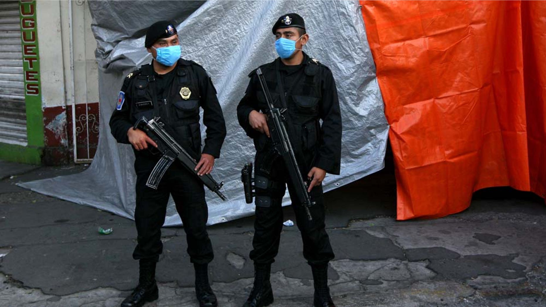 Mexico City police guard a refrigerated truck carrying bodies that were found in mass graves in northern Mexico, after it arrived in Mexico City, Thursday April 14, 2011. Mexican investigators found a clandestine grave with six bodies in Tamaulipas state, bringing to 122 the number of bodies found in pits in a region near the U.S. border that is wracked by battling drug cartels, authorities said Wednesday. (AP Photo/Marco Ugarte)