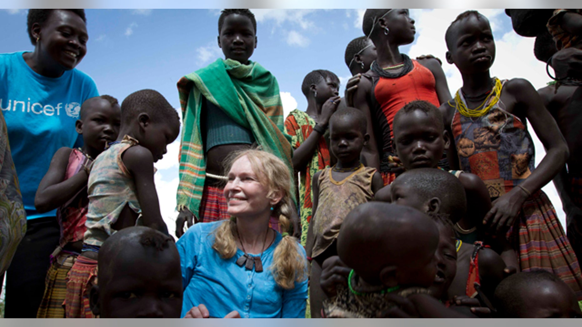 July 15: UNICEF Goodwill Ambassador, US actress Mia Farrow with a group of Karimojong children at a Tokul near the town of Kitodo, in the far north west of Uganda. (AP)