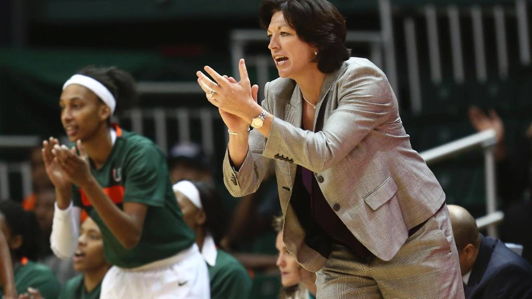FILE - In this Feb. 13, 2014, file photo, Miami coach Katie Meier yells instructions to her team during the first half of an NCAA college basketball game against Maryland in Coral Gables, Fla. Meier is now under contract to lead Miami's women's basketball program through 2021, with an extension being announced Monday, Oct. 13, 2014, by the school. Financial terms of the deal were not released. Meier, however, revealed that she donated $75,000 to support women's sports at the school, a pledge that has already gotten several longtime Hurricane supporters to follow suit. (AP Photo/J Pat Carter, File)