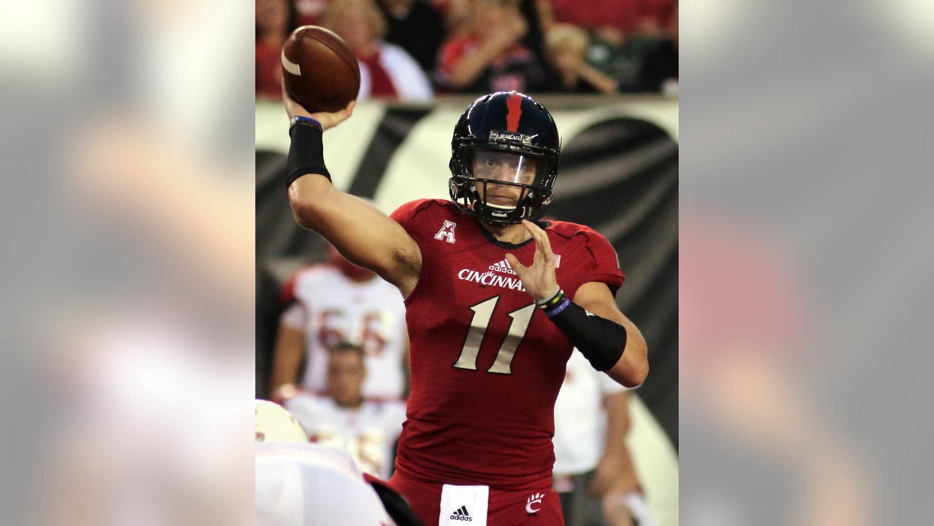 Cincinnati's quarterback Gunner Kiel passes the ball against Miami (Ohio) in the first half of an NCAA college football game in Cincinnati, Saturday, Sept. 20, 2014. (AP Photo/Tom Uhlman)