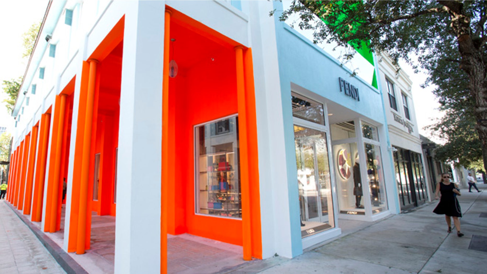 FILE - In this Oct. 30, 2015, file photo, a pedestrian walks past a Fendi store in the Miami Design District in Miami. A proliferation of luxury stores in Miami is serving wealthy Latin Americans fleeing financial and political turmoil in their countries. (AP Photo/Wilfredo Lee, File)