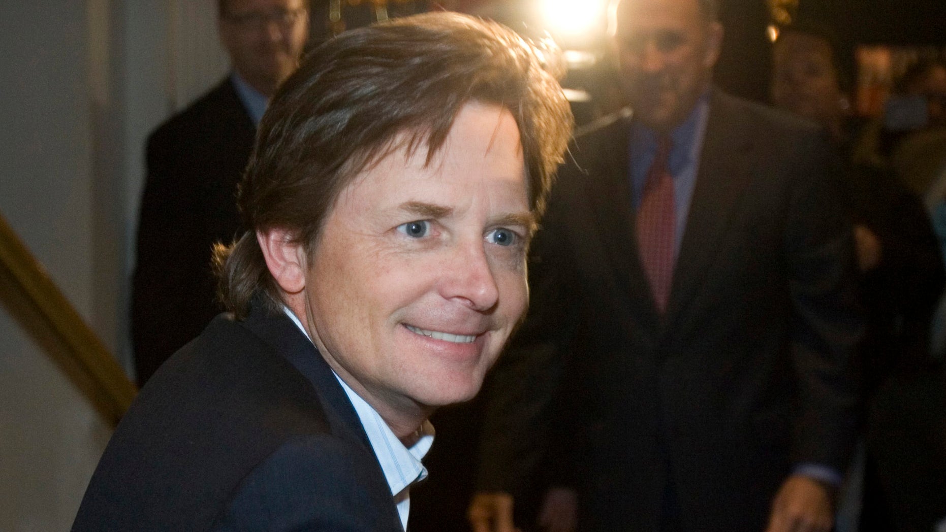 File -- In a Nov. 6, 2006 file photo actor Michael J. Fox greets supporters at a rally for Wisconsin Gov. Jim Doyle in Milwaukee. On his upcoming NBC comedy, Fox will play a newscaster who quits his job because of Parkinson's Disease but returns to work in the show's first episode because a new medical regimen has helped him control many of the disease's symptoms. NBC said Sunday, Jan. 6, 2013, his comedy closely tracks many aspects of Fox's personal life and tries to have fun with an image that has left him an object of pity-fueled admiration.(AP Photo/Morry Gash, File)