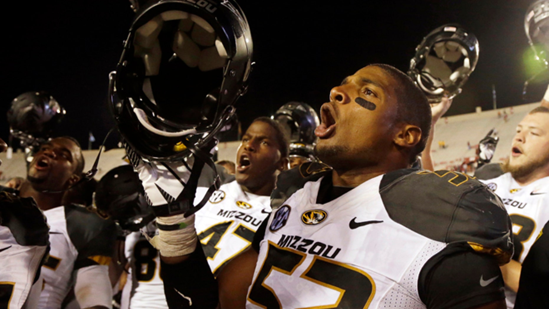 FILE - In this Sept. 21, 2013, file photo, Missouri's Michael Sam (52) sings the school song after Missouri defeated Indiana in an NCAA college football game in Bloomington, Ind. The All-American athlete says he is gay, and the defensive end could become the first openly homosexual player in the NFL. (AP Photo/Darron Cummings, File)
