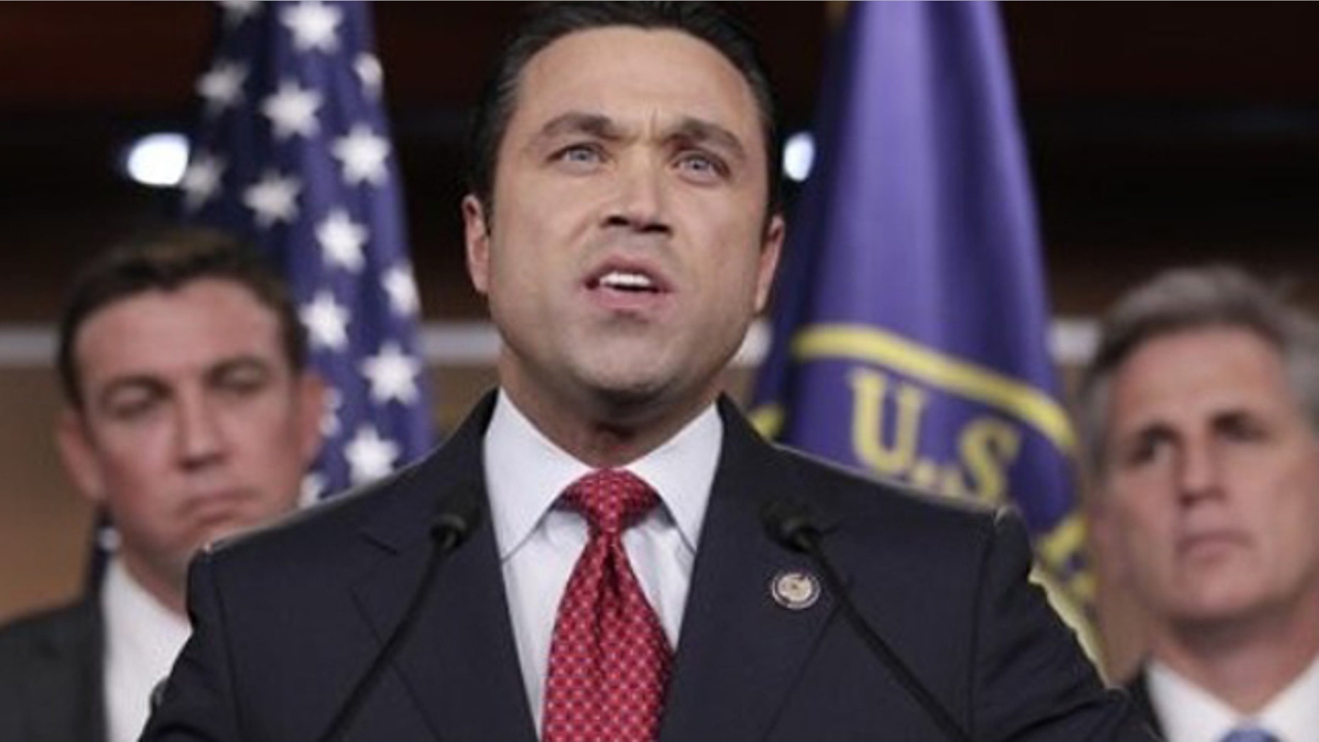 FILE: Rep. Michael Grimm, R-N.Y., center, accompanied by Rep. Duncan Hunter, R-Calif., left, House Majority Whip Kevin McCarthy of Calif., speaks during a news conference on Capitol Hill.