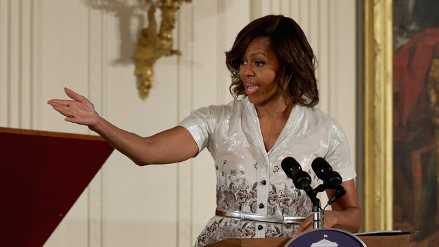 WASHINGTON, DC - MAY 12: First lady Michelle Obama delivers remarks during the annual Mother's Day tea to honor military mothers at the White House May 12, 2014 in Washington, DC. Part of the Joining Forces initiative, Obama and Dr. Jill Biden also helped military kids create Mother's Day cards and homemade gifts, which the children presented to their mothers and grandmothers. (Photo by Chip Somodevilla/Getty Images)