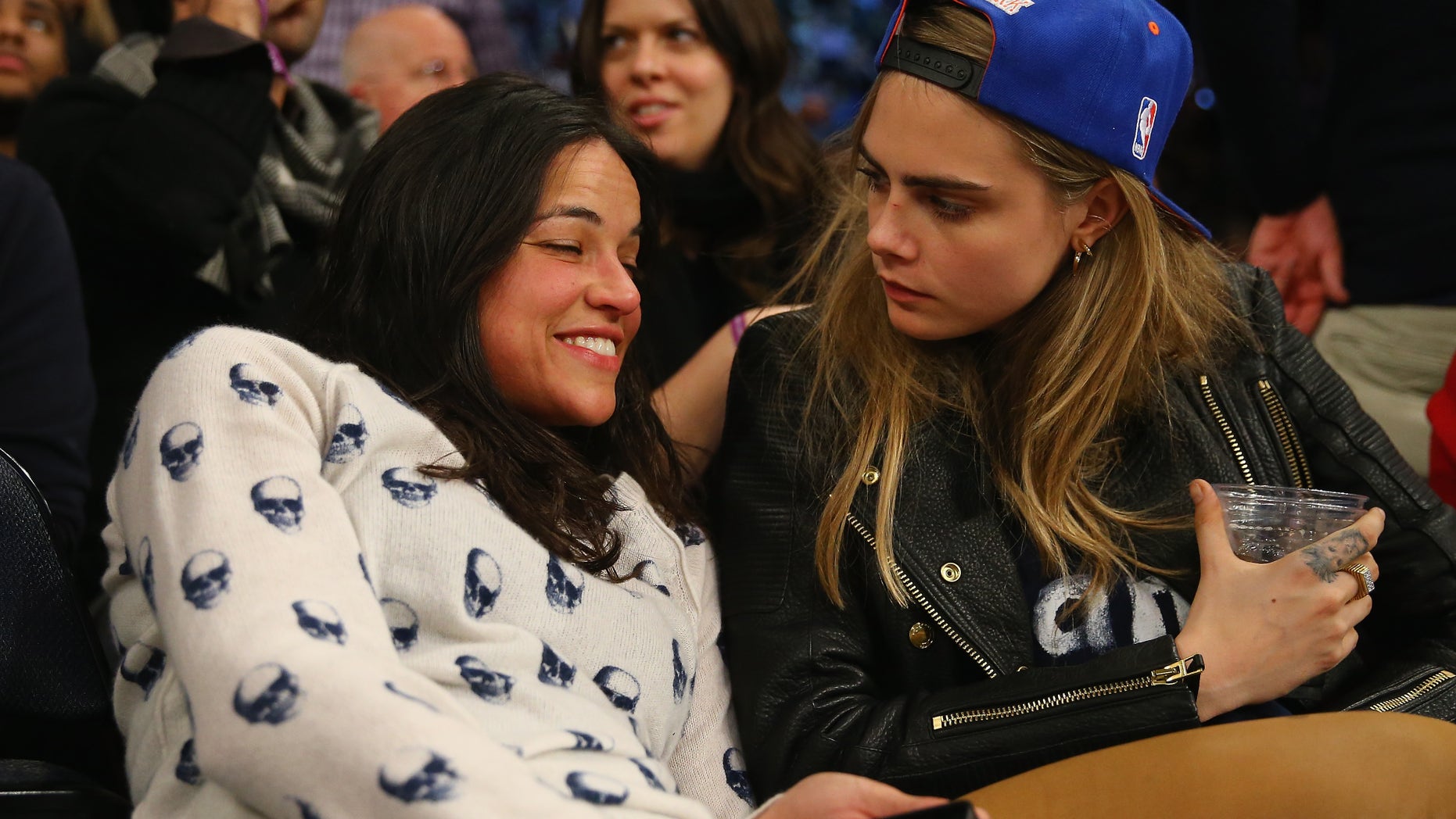 NEW YORK, NY - JANUARY 07: Actress Michelle Rodriguez sits with with model Cara Delevingne during the game between the New York Knicks and the Detroit Pistons at Madison Square Garden on January 7, 2014 in New York City. NOTE TO USER: User expressly acknowledges and agrees that, by downloading and/or using this photograph, user is consenting to the terms and conditions of the Getty Images License Agreement. (Photo by Al Bello/Getty Images)