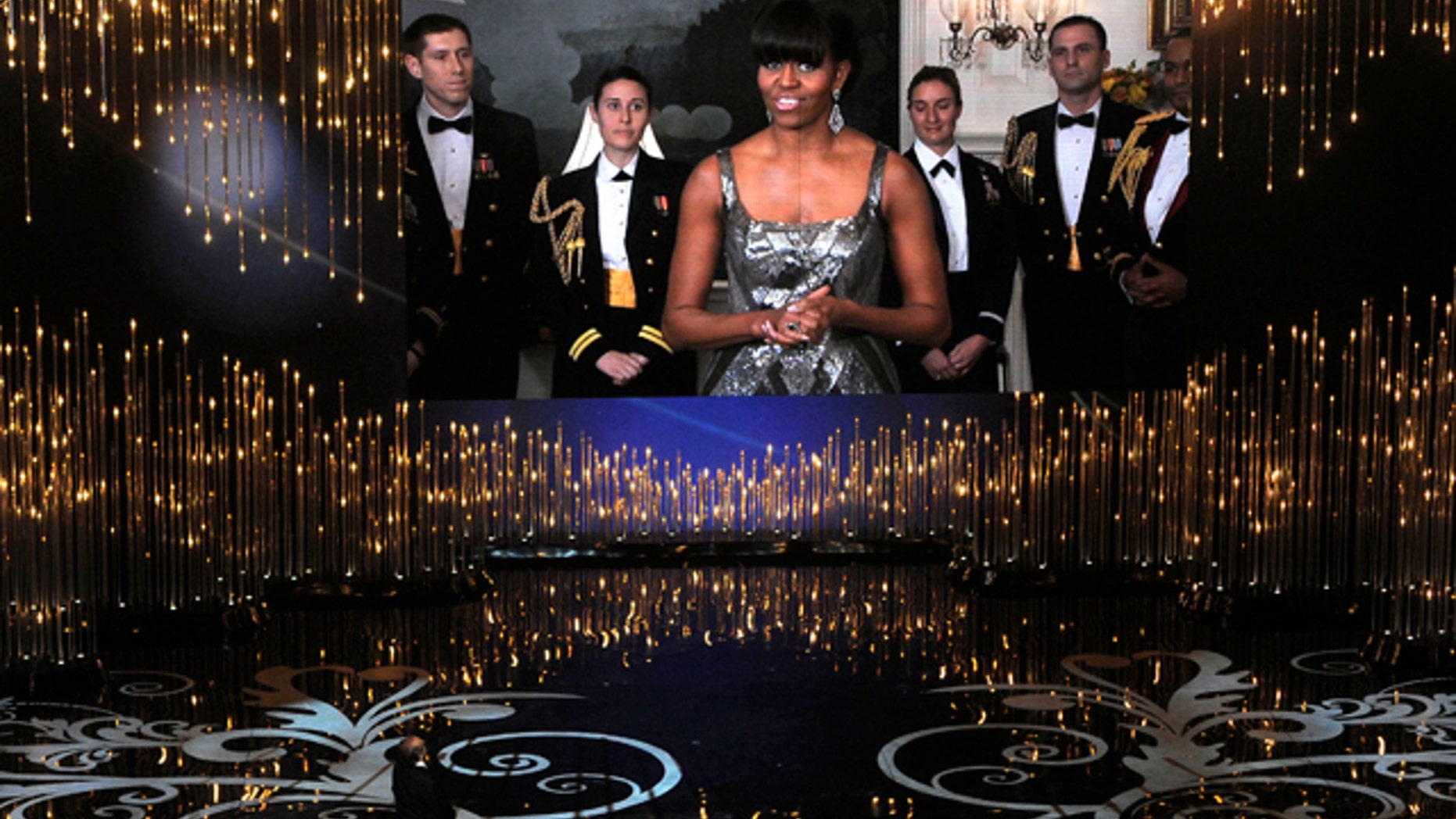 Feb. 24, 2013: First lady Michelle Obama, appearing on screen from Washington, and actor Jack Nicholson present the award for best picture during the Oscars.