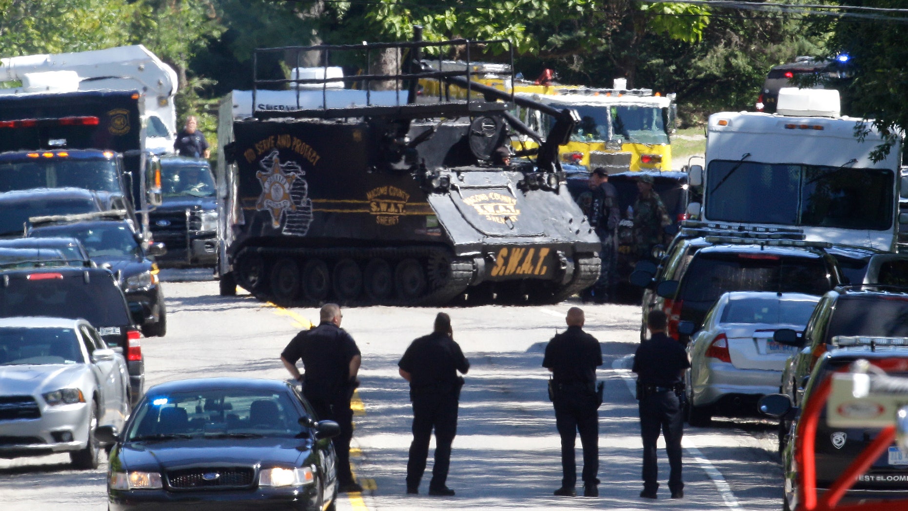 Sept. 10, 2012: An armored vehicle advances on a house where they believe a man suspected in the fatal shooting of a police officer had barricaded himself inside in West Bloomfield, Mich.