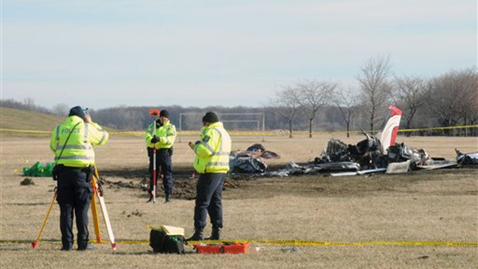 March 30: Monroe City Police take measurements while investigating the site of a small plane crash in Monroe, Michigan.