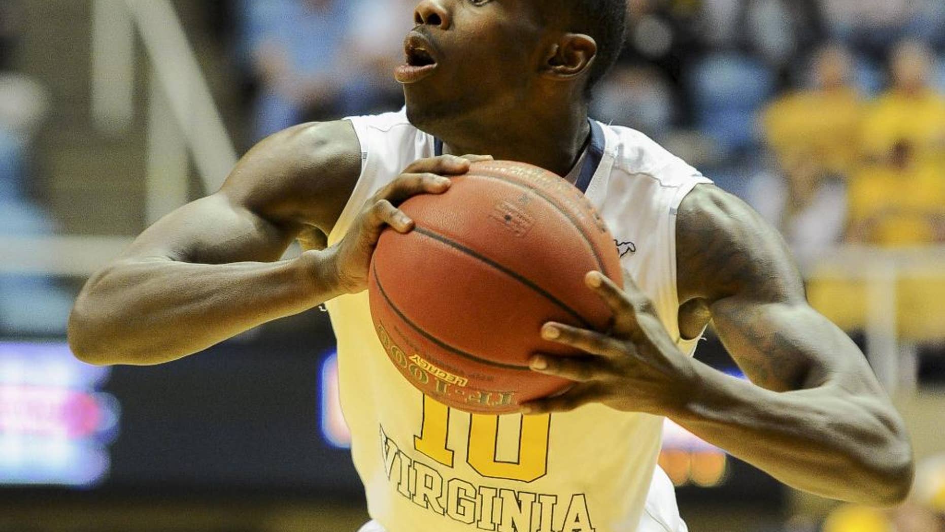 FILE - In this Nov. 21, 2013 file photo, West Virginia's Eron Harris (10) looks to pass during the second half of an NCAA college basketball game against Georgia Southern in Morgantown, W.Va. High-scoring guard Eron Harris is transferring to Michigan State from West Virginia. His father, Eric Harris, says Monday, June 9, 2013, that offers were turned down from Michigan, Wisconsin, Purdue and UCLA. (AP Photo/Andrew Ferguson, File)