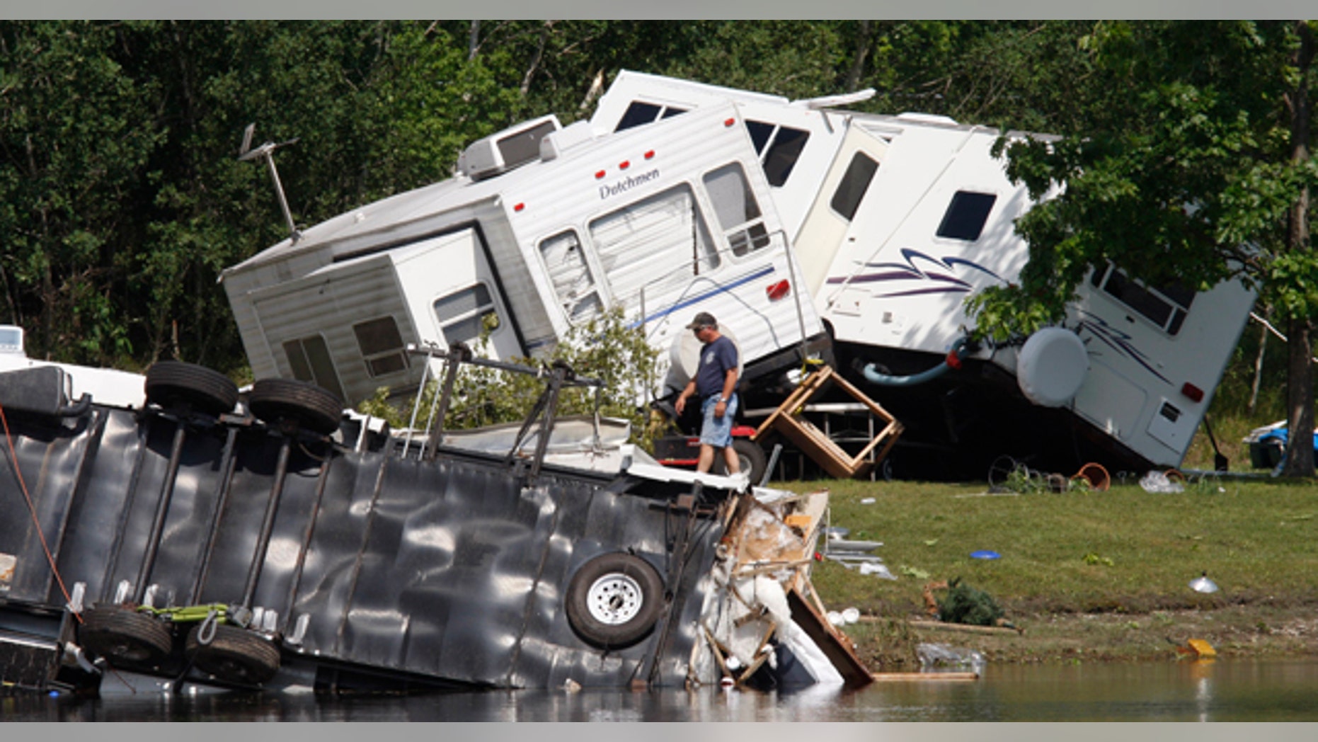 June 28: Overturned trailers are shown at the Fort Trodd Family Campground in Clyde Township, Mich. (AP)