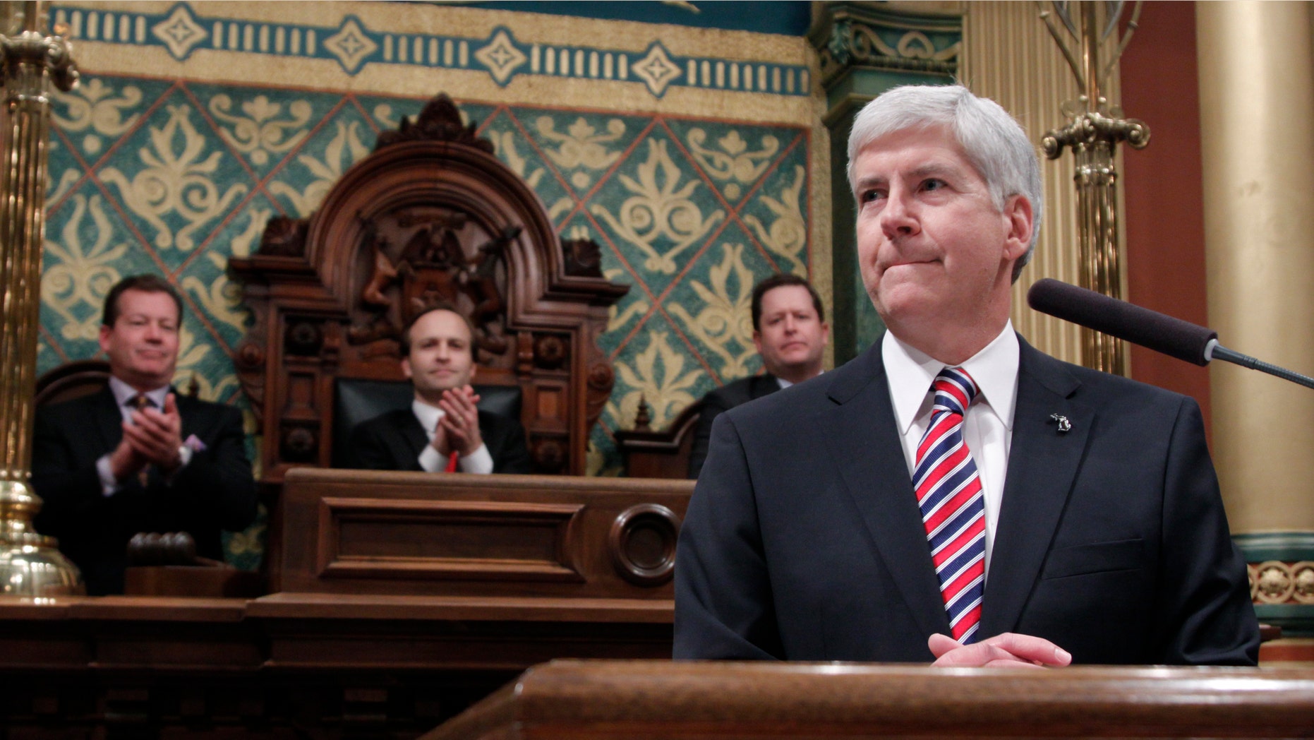 Senate Majority Leader Randy Richardville, R-Monroe, from left, Lt. Gov. Brian Calley, and House Speaker Jase Bolger, R-Marshall, applaud as Michigan Gov. Rick Snyder, right, delivers his State of the State address to a joint session of the House and Senate, Thursday, Jan. 16, 2014, in the House Chambers of the state Capitol in Lansing, Mich. (AP Photo/Al Goldis)