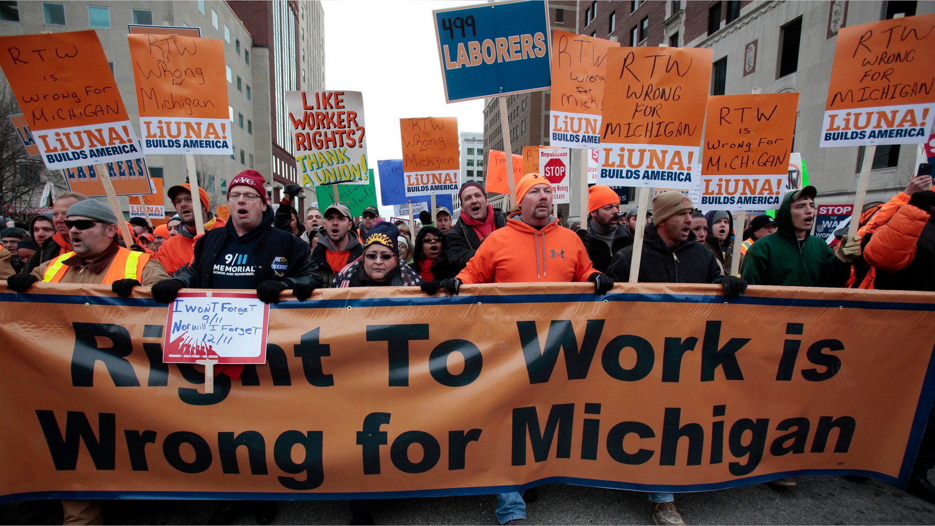 FILE: Dec. 11, 2012: Union members and supporters march to the Michigan State Capitol to protest against right-to-work legislation, in Lansing, Mich.