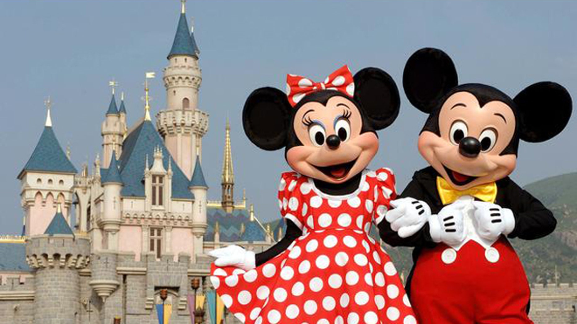 In this photo released by Hong Kong Disneyland, Disney characters Mickey Mouse and Minnie Mouse pose in front of the Sleeping Beauty Castle in Hong Kong's Disneyland Park Thursday, Sept. 1, 2005. Hong Kong Disneyland is due to open Sept. 12. Intellectuals decried the invasion of American pop culture when the last Disneyland opened in Paris in 1992, but Hong Kong has rolled out the red carpet for Mickey Mouse and Donald Duck. ( AP Photo/Disneyland, Mark Ashman)