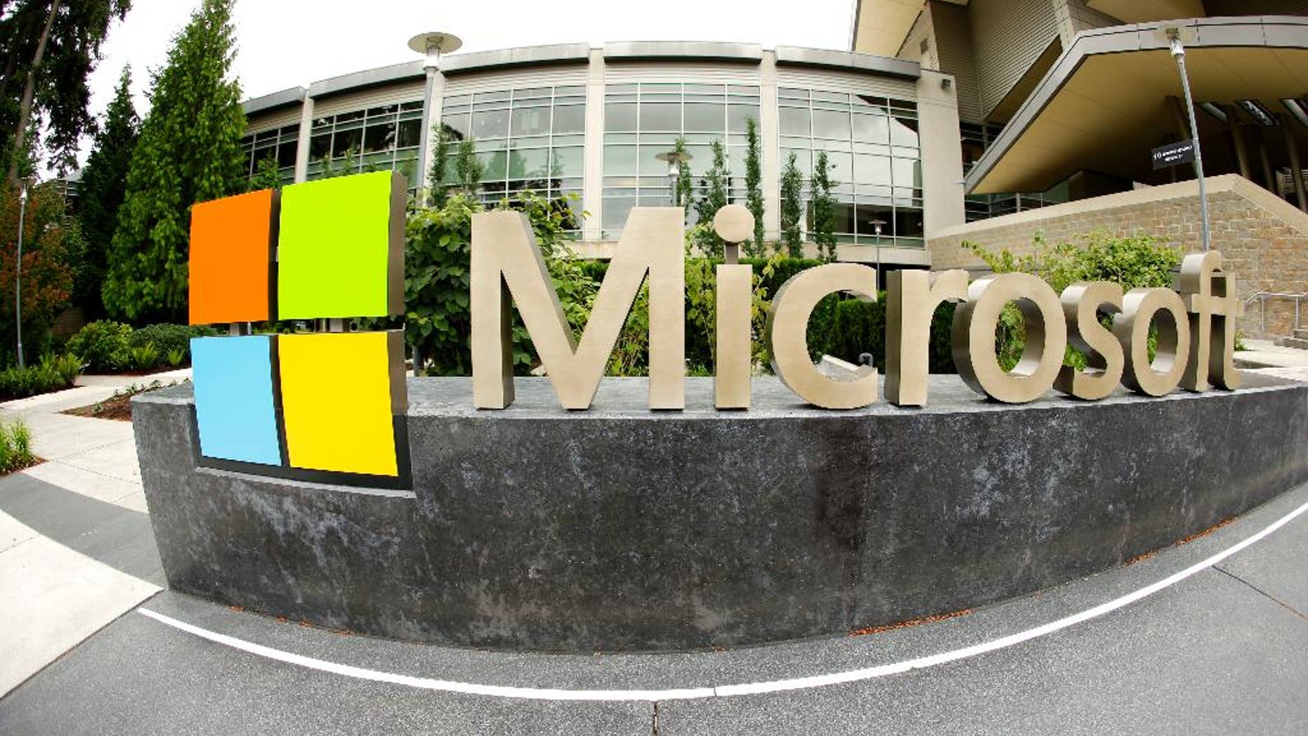 FILE - This July 3, 2014 file photo taken with a fisheye lens shows Microsoft Corp. signage outside the Microsoft Visitor Center in Redmond, Wash. Microsoft will acquire Stockholm-based game maker Mojang, the maker of the popular game Minecraft for $2.5 billion, the company announced Monday, Sept. 15, 2014. (AP Photo Ted S. Warren, File)