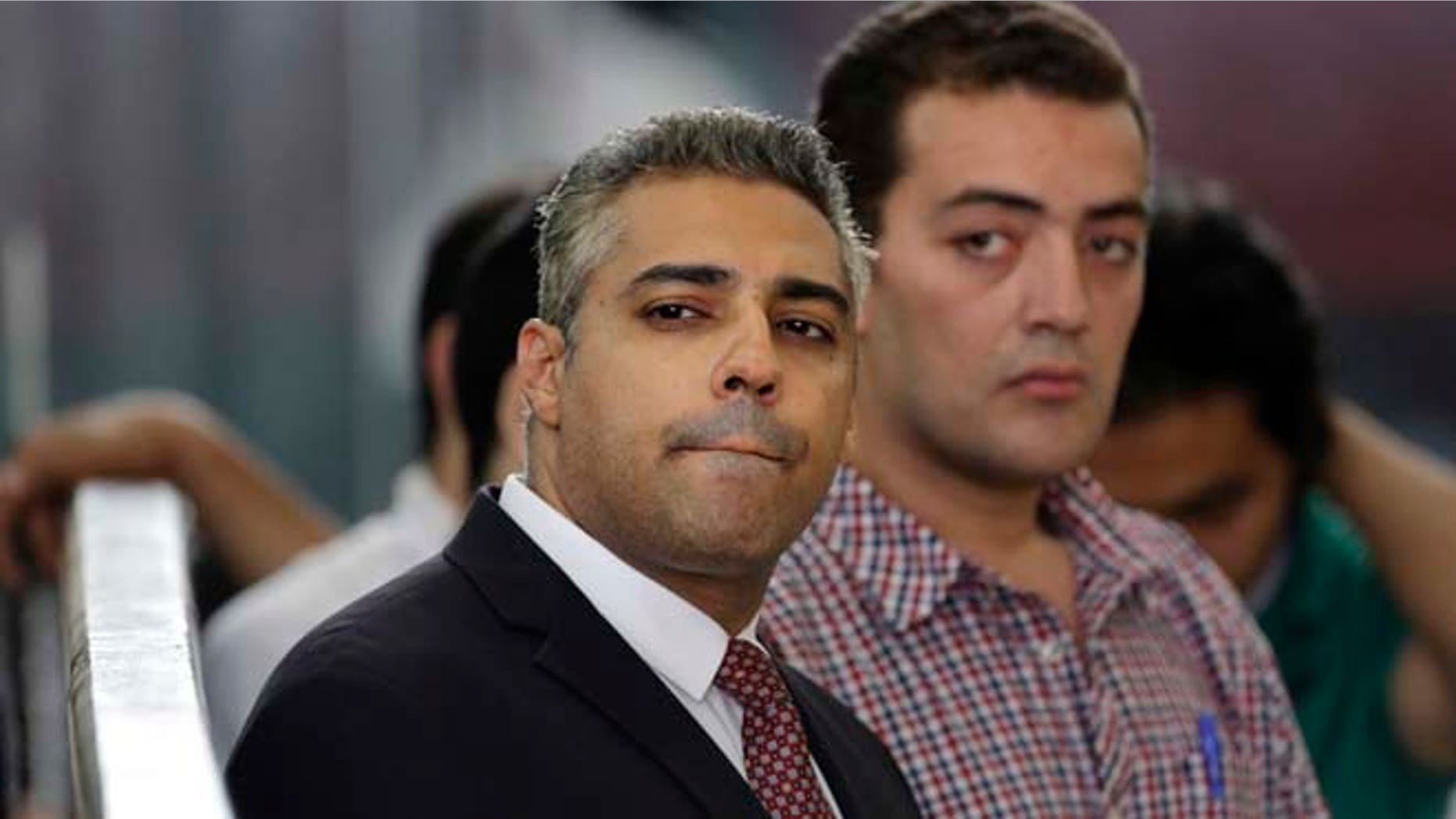 June 4, 2015: Canadian Al-Jazeera English journalist Mohammed Fahmy, left, and his Egyptian colleague Baher Mohammed listen in a courtroom in Tora prison in Cairo, Egypt.