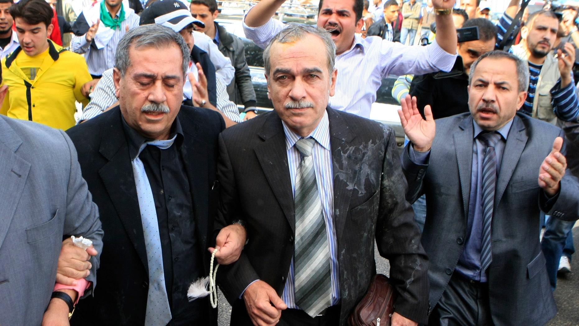 Nov. 9, 2011: Syrian protesters throw eggs toward Abdul-Aziz al-Khair, a member of the Syrian National Coordination Committee, center, and other opposition leaders as they try to enter the Arab League headquarters where they were to hold talks with the organization's chief on violence in Syria, in Cairo, Egypt.