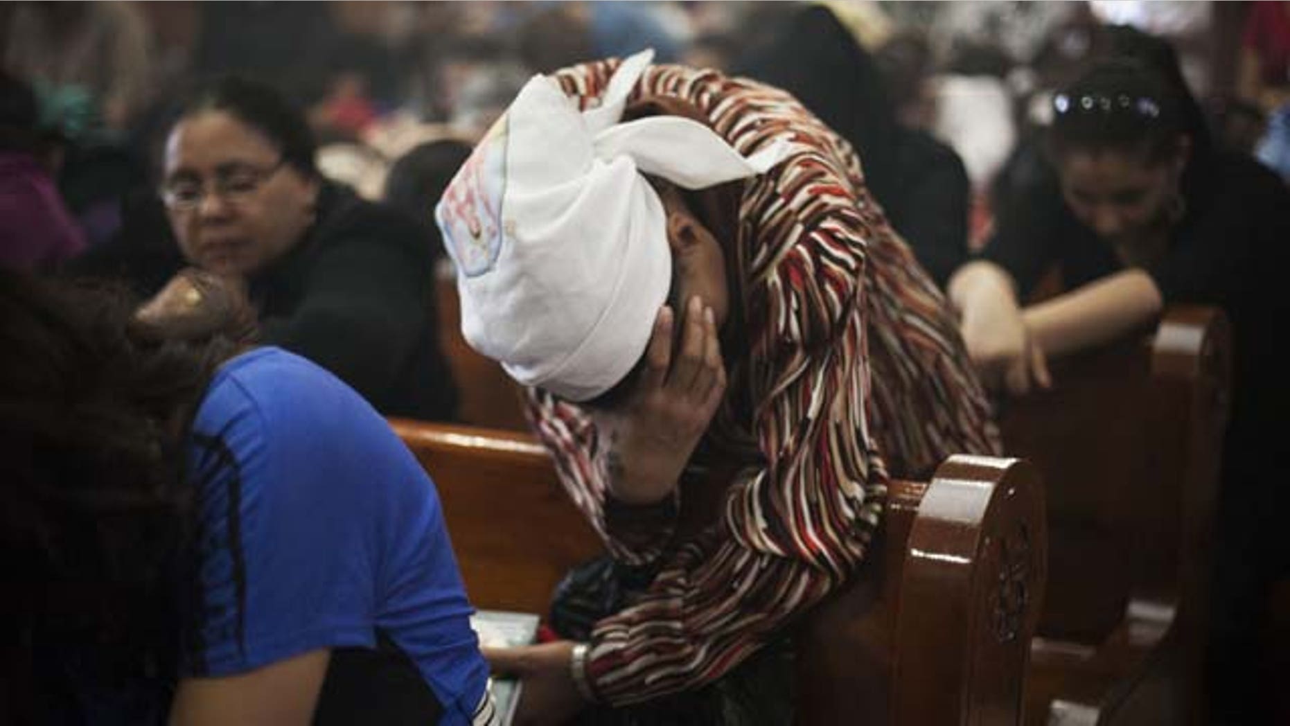 August 6, 2013: An Egyptian Coptic Christian woman prays in a church within Al-Mahraq Monastery in Assiut, Upper Egypt.