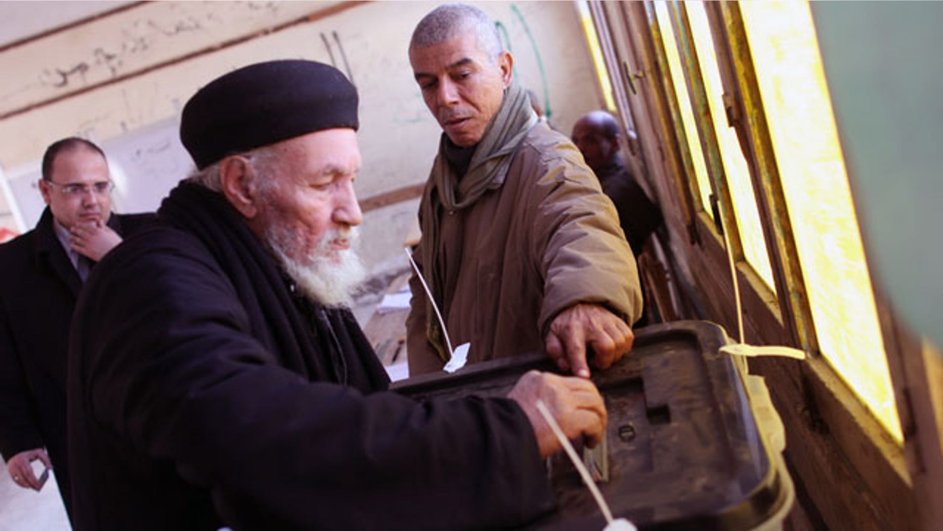 January 15, 2014: Father Antonious casts his ballot in a constitutional referendum inside a polling station in Dalga village of Minya, Egypt. Father Antonious is one of the priests of the Virgin Mary and St. Abraam Monastery that was looted and burned by supporters of ousted Islamist President Mohammed Morsi in August. Christians are voting "yes" on a new charter that criminalizes discrimination and instructs the next legislature to ease restrictions on building churches. (AP Photo/Roger Anis, El Shorouk Newspaper)