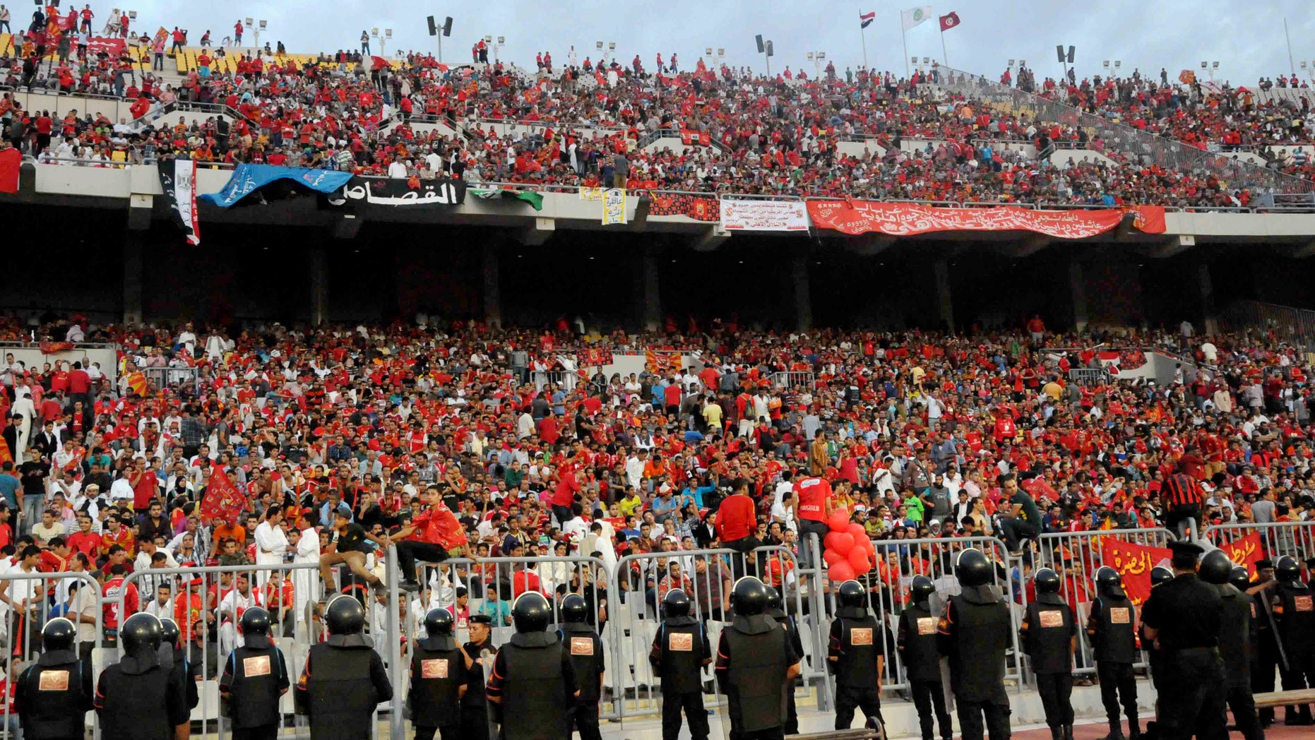 Nov. 4, 2012: In this file photo, Egyptian riot police stand guard at the Borg El-Arab Stadium stadium near Alexandria, Egypt, before Egypt's Al-Ahly club takes on Tunisia's Esperance for a match in the first leg of the African Champions League final near Alexandria, Egypt.