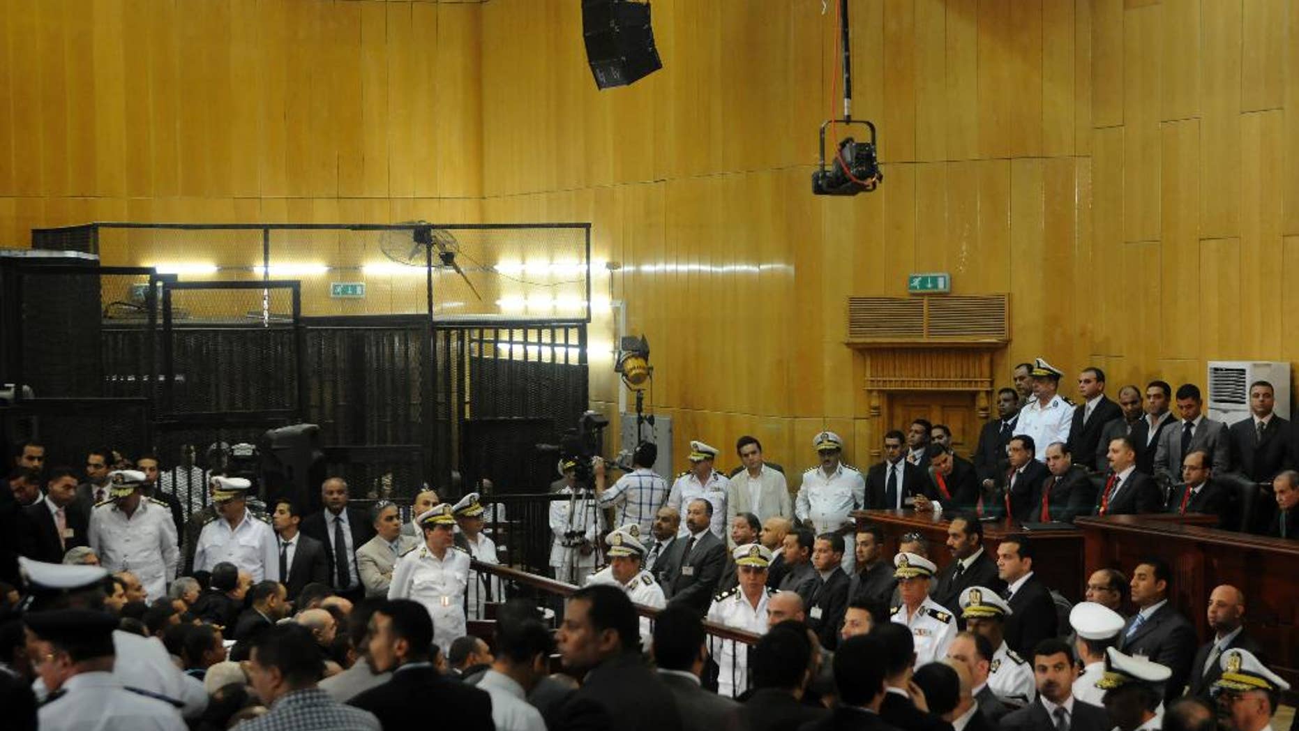 FILE - In this Saturday, June 2, 2012 file photo, people gather inside a courtroom to hear a verdict in the trial of former Egyptian President Hosni Mubarak, his sons and several security officers in Cairo, Egypt, Saturday, June 2, 2012. A verdict sentencing more than 520 people to death on Monday, March 24, 2014 after a cursory mass trial has drawn new attention on Egypt’s judiciary, where many judges are strong backers of the military and sharp opponents of Islamists, operating amid a media frenzy calling for swift and harsh verdicts against the Muslim Brotherhood.(AP Photo, File)
