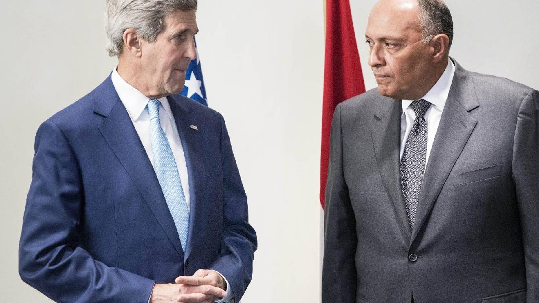 U.S. Secretary of State John Kerry, left, and Egyptian Foreign Minister Sameh Hassan Shoukry speak to journalists before a meeting at a hotel in Cairo, Egypt Sunday, June 22, 2014. Kerry arrived Sunday in the Egyptian capital to meet with Egyptian officials including President Abdel-Fattah el-Sissi in the highest-level American outreach since he took office. The United States is moving forward with attempts to thaw relations with Egypt that have cooled over concerns that the government in Cairo has conducted sham trials, imprisoned journalists and issued a violent crackdown on its political enemies. (AP Photo/Brendan Smalowski, Pool)