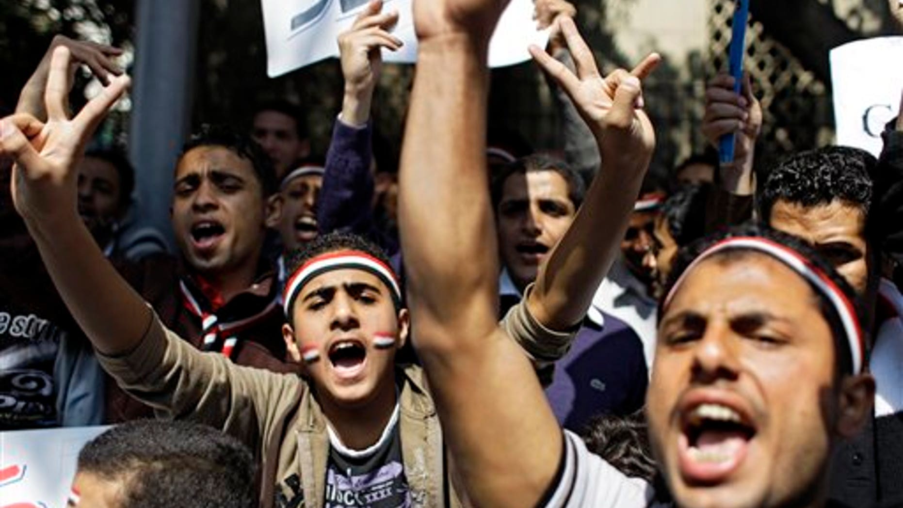 March 12: People shout slogans as they protest outside the Arab League headquarters in Cairo, Egypt, to urge Arab foreign ministers meeting to approve a no-fly zone over Libya to protect the civilian population from Libyan leader Muammar Qaddafi's fighter jets. (AP)
