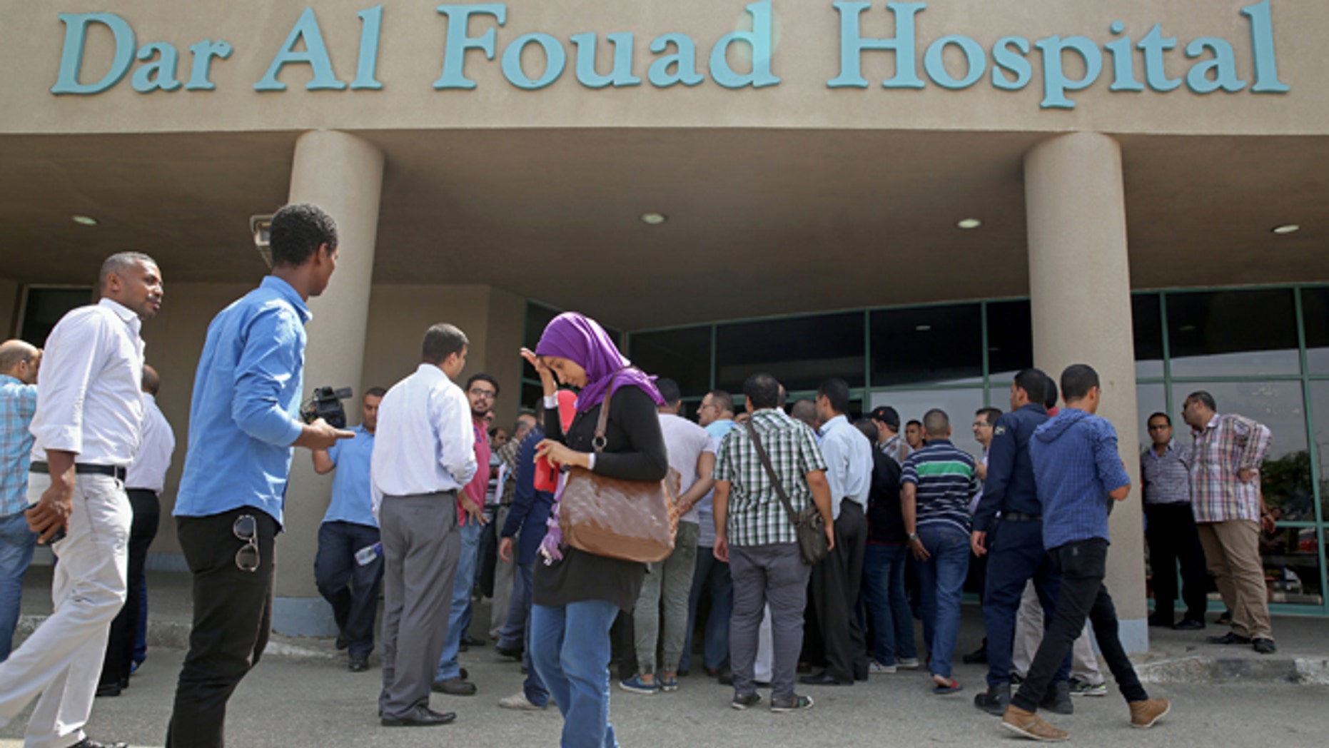 Sept. 14, 2015: Egyptian journalists wait for information about tourists who were injured Sunday while on a desert safari trip.