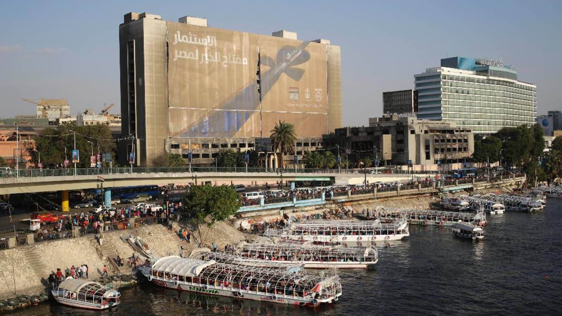 April 14, 2015: A banner reading, "Investment is the key to Egypt's welfare," hangs from the former National Democratic Party (NDP) headquarters, which was torched during the 2011 uprising that ousted President Hosni Mubarak, in Cairo.