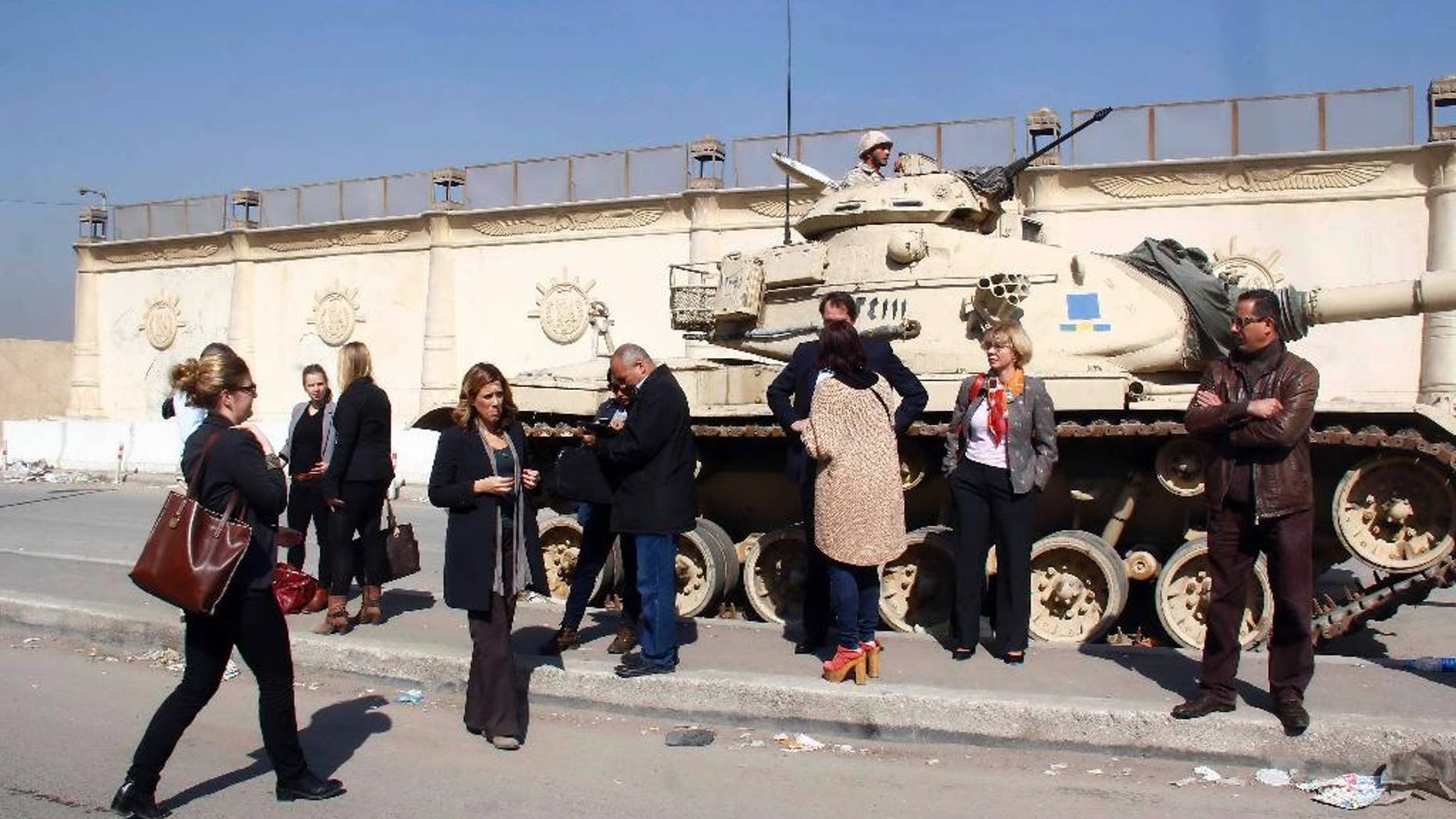 FILE - In this Thursday, Feb. 20, 2014 file photo, Journalists wait outside a court adjacent to Tora prison, in Cairo, Egypt. Egyptian human rights lawyers said on Monday, Oct. 26, 2015 they are concerned that recent amendments to prison laws, which give administrators wider leeway for the use of force, could open the door to more violations in Egypt’s prisons, despite some amendments they see as positive. (AP Photo/El Shorouk newspaper, Jihan Nasr, File) EGYPT OUT