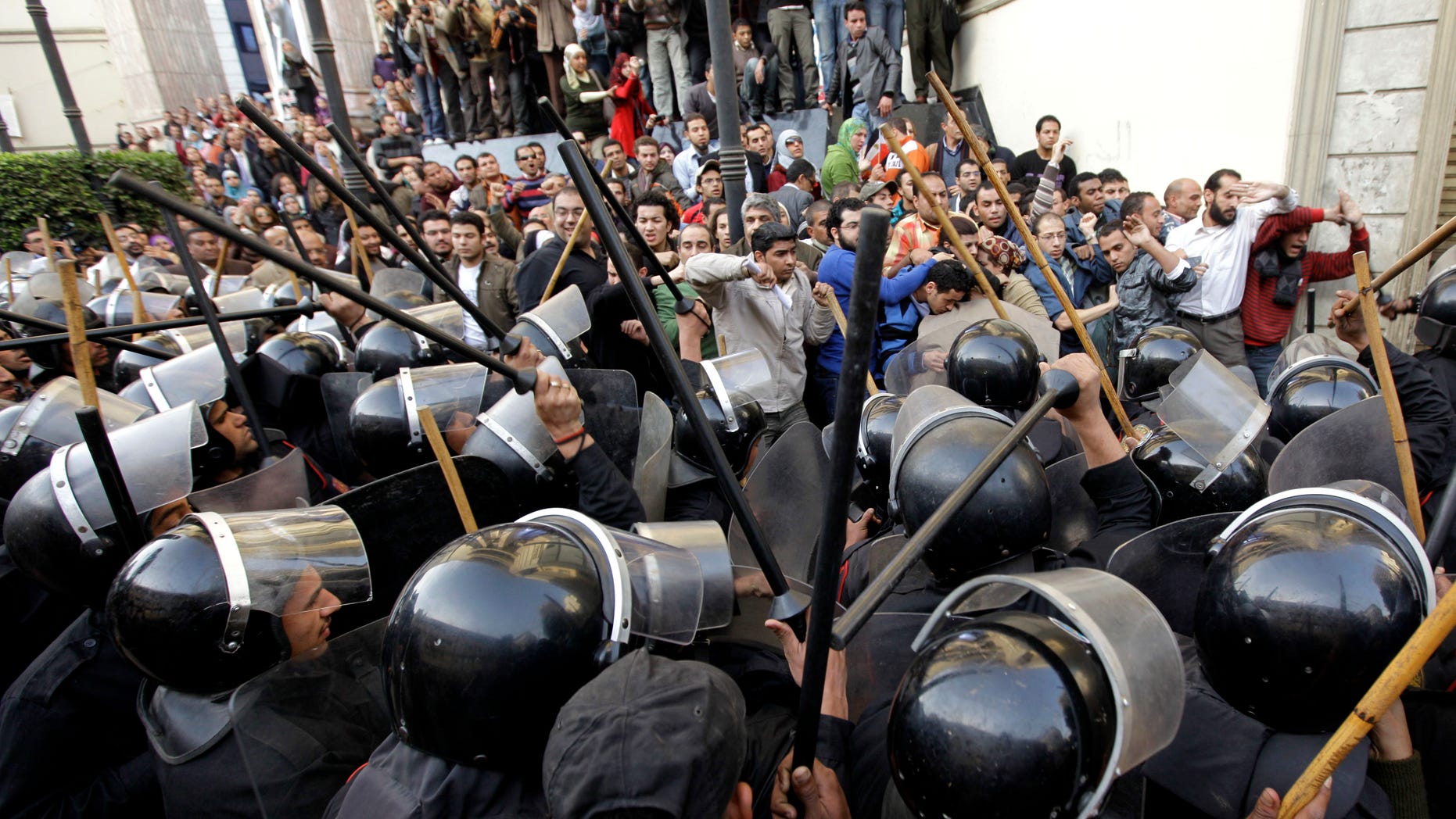 Jan. 26, 2011: Egyptian anti-riot police confront Egyptian activist outside a journalists syndicate in downtown Cairo, Egypt. A small gathering of Egyptian anti-government activists tried to stage a second day of protests in Cairo Wednesday in defiance of a ban on any gatherings, but police quickly moved in and used force to disperse the group.