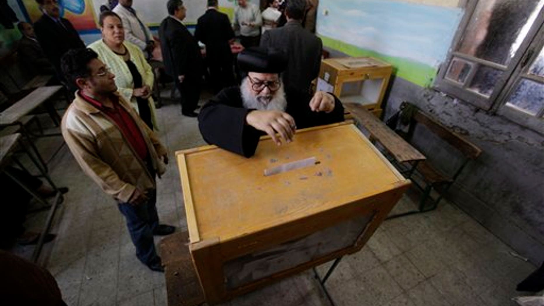 March 19: An Egyptian priest casts his vote at a polling station in Cairo, Egypt on referendum on constitutional amendments. (AP)