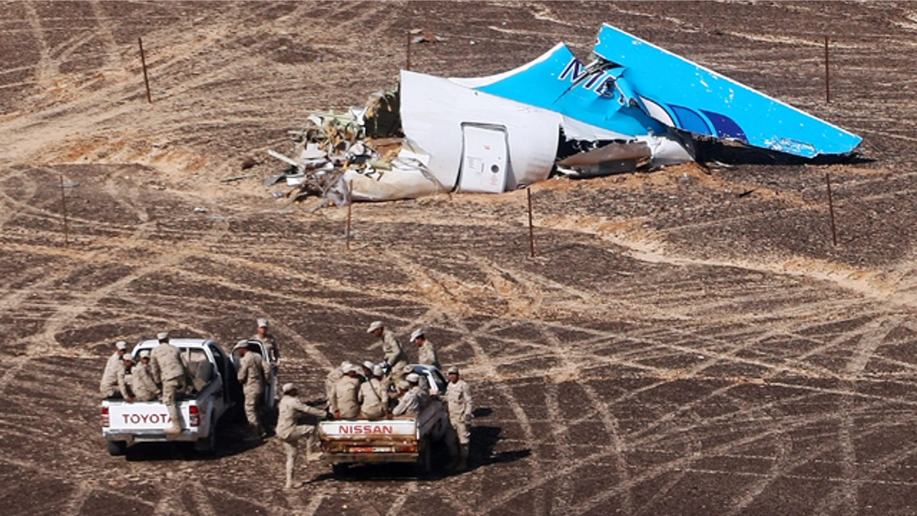 FILE - In this Sunday, Nov. 1, 2015 photo provided by Russian Emergency Situations Ministry, Egyptian Military on cars approach a plane's tail at the wreckage of a passenger jet bound for St. Petersburg in Russia that crashed in Hassana, Egypt. (Maxim Grigoriev/Russian Ministry for Emergency Situations via AP, File)