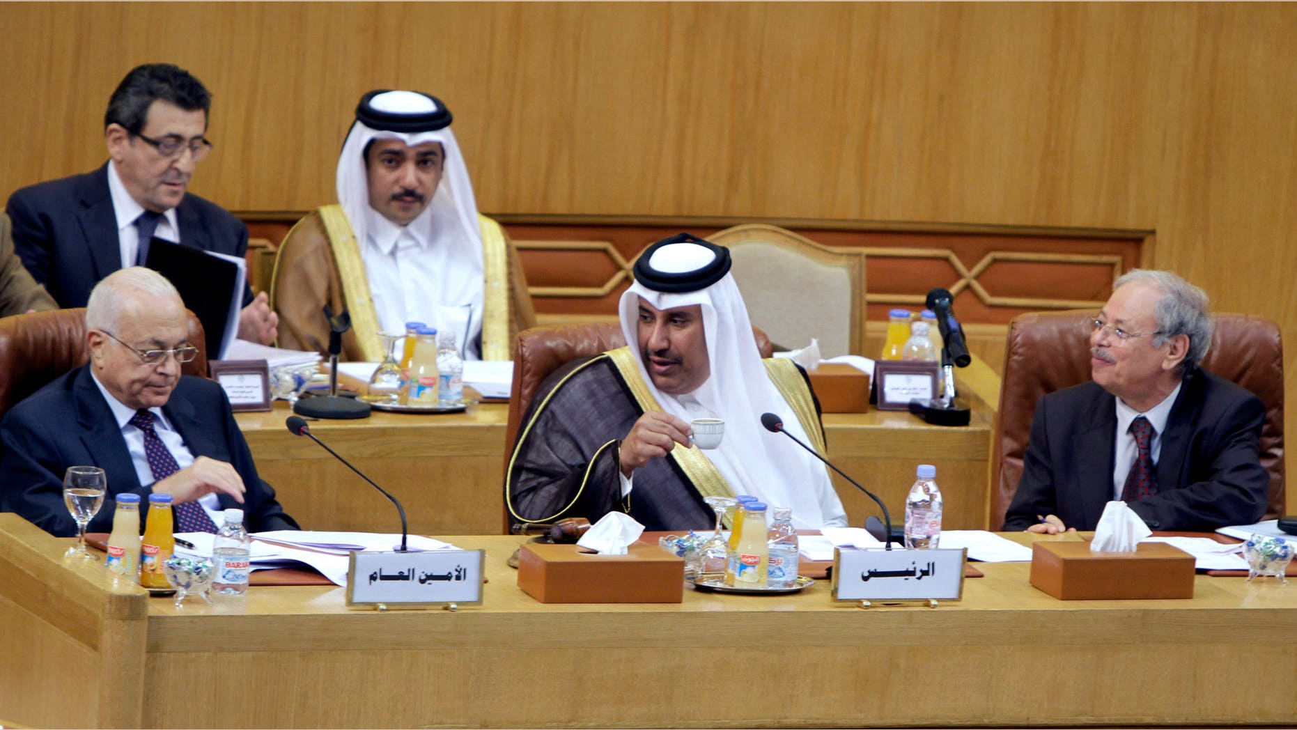 Nov. 12, 2011: Qatari Foreign Minister Hamad bin Jasim, center, looks at Arab League secretary-general Nabil al-Arabi Nabil, left, during an Arab League emergency session on Syria at the Arab League headquarters in Cairo, Egypt.