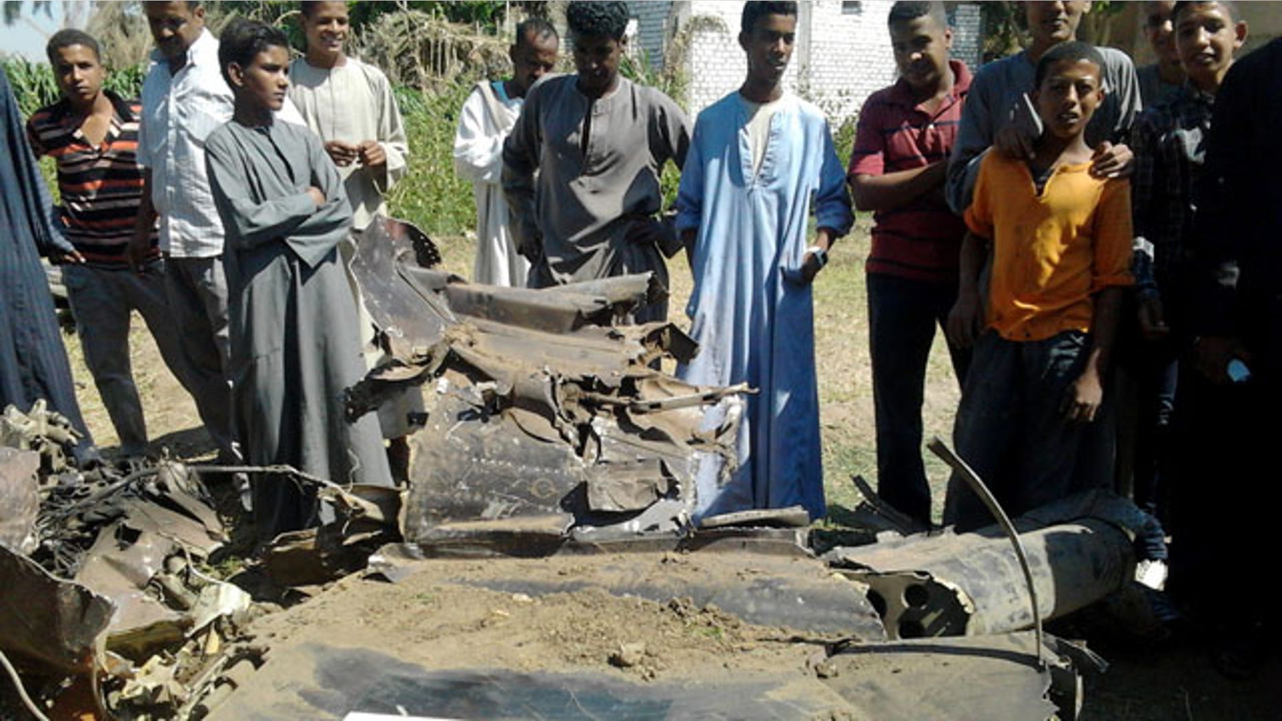 October 13, 2013: Egyptians gather around the remains of a Soviet-made MiG-21 fighter jet belonging to the Egyptian air force that crashed Sunday, while on a training mission near the southern ancient city of Luxor, which officials said killed a villager on the ground and injured several. (AP Photo)