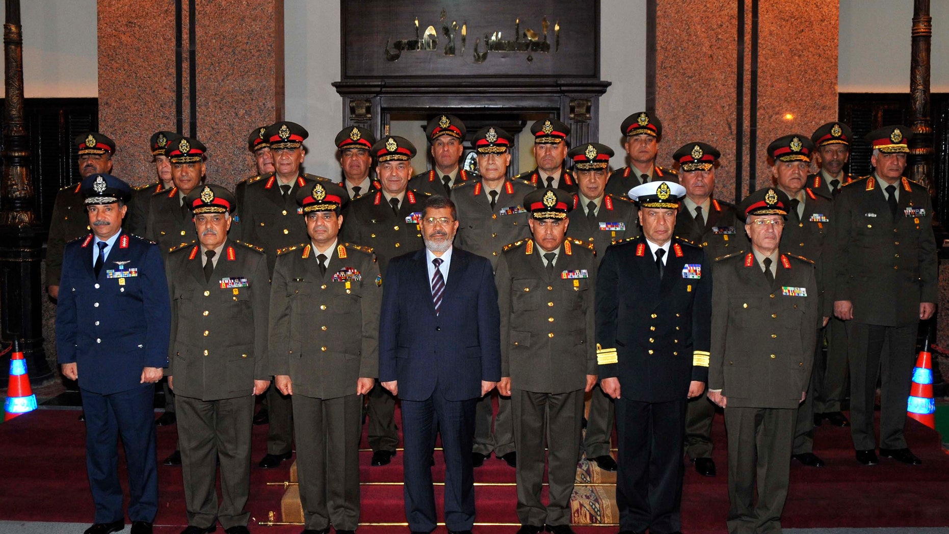April 11, 2013: In this image released by the Egyptian Presidency, Egyptian President Mohammed Morsi, center, poses with military officers after a meeting with the Supreme Council of the Armed Forces in Cairo, Egypt.