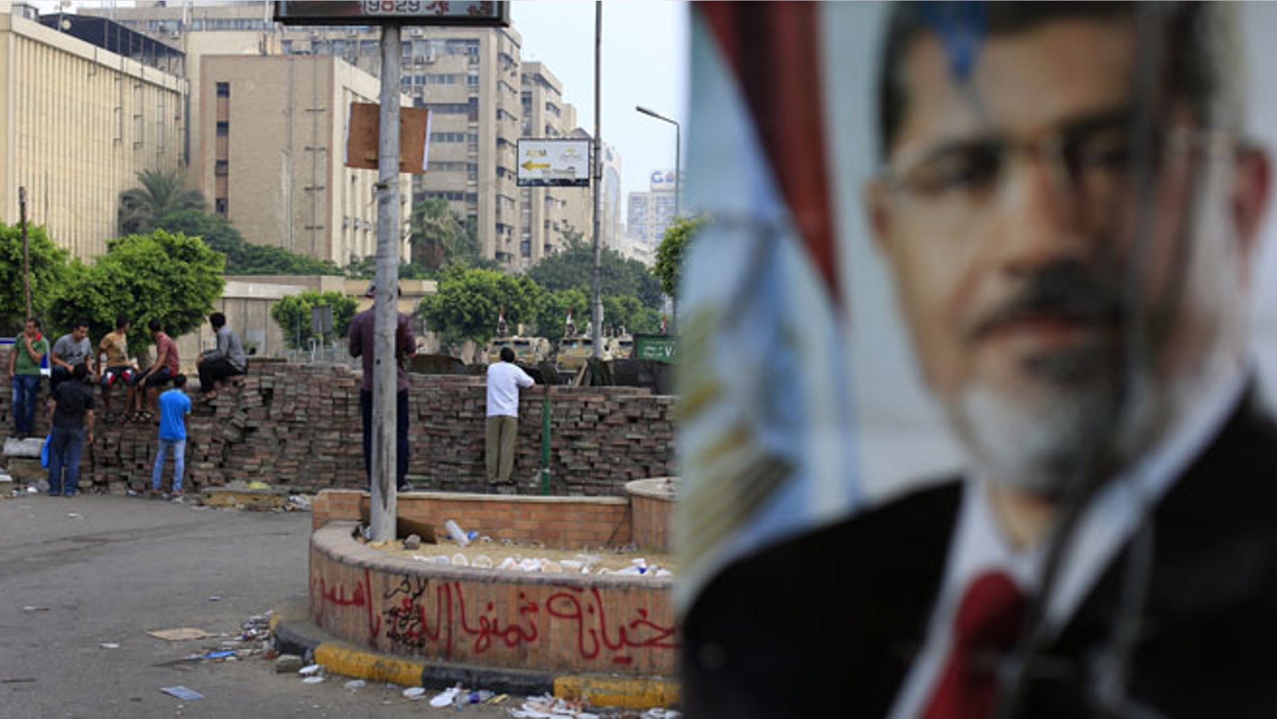 July 10, 2013: Supporters of ousted President Mohammed Morsi protest as army soldiers guard at the Republican Guard building in Nasr City, in Cairo, Egypt.
