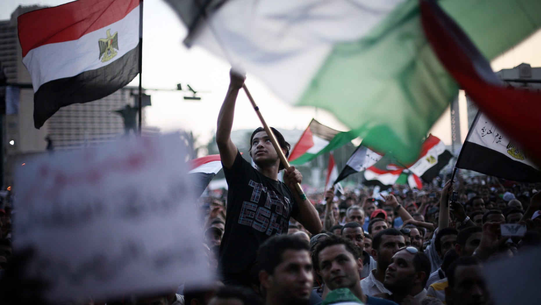 June 21, 2012: Egyptian protesters wave national flags and banners in Tahrir Square in Cairo, Egypt.