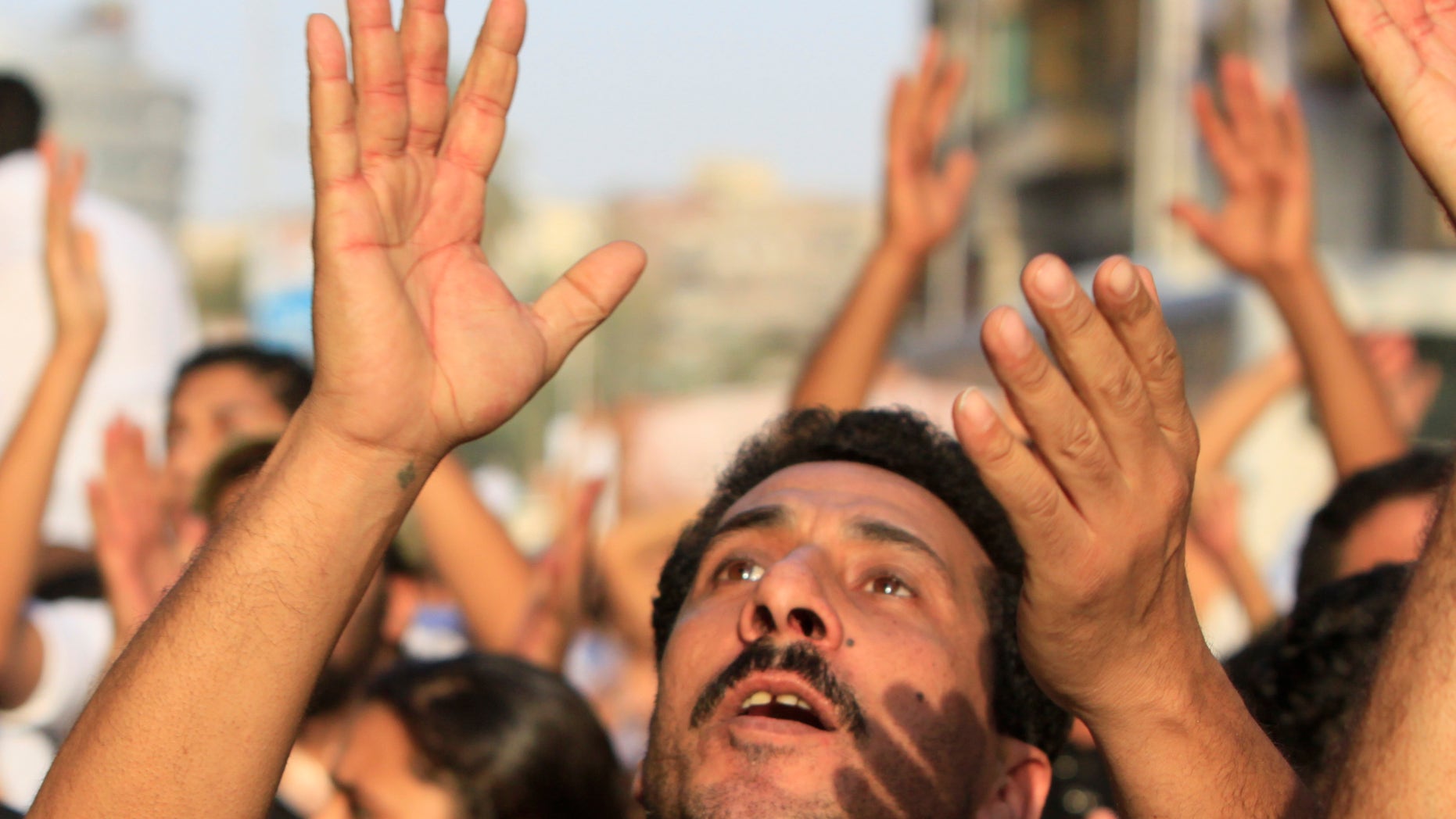 Angry Egyptian Christians protest against the military ruling council in Cairo Egypt, Monday, Oct.10, 2011, a day after at least more than two dozen were killed when Christians, angered by a recent church attack, clashed Sunday night with Muslims and security forces outside the state television building in central Cairo.