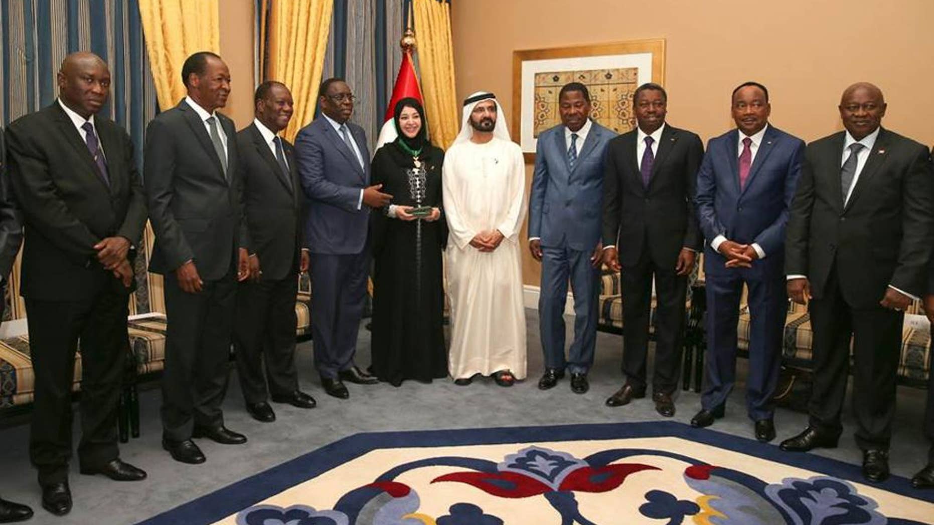 This handout photo made available by Dubai Media Office shows the UAE Vice President, Prime Minister and Ruler of Dubai, Sheikh Mohammed bin Rashid Al Maktoum, center, and Reem Ebrahim Al Hashimi, Minister of State, on his left, as they receive the Presidents and the presidential delegations from the eight UEMOA nations: Benin, Burkina-Faso, Cote d’Ivoire, Guinea- Bissau, Mali, Niger, Senegal, and Togo at the West African Investment Forum in Dubai, United Arab Emirates, Tuesday, Sept. 9, 2014. (AP Photo/Dubai Media Office)