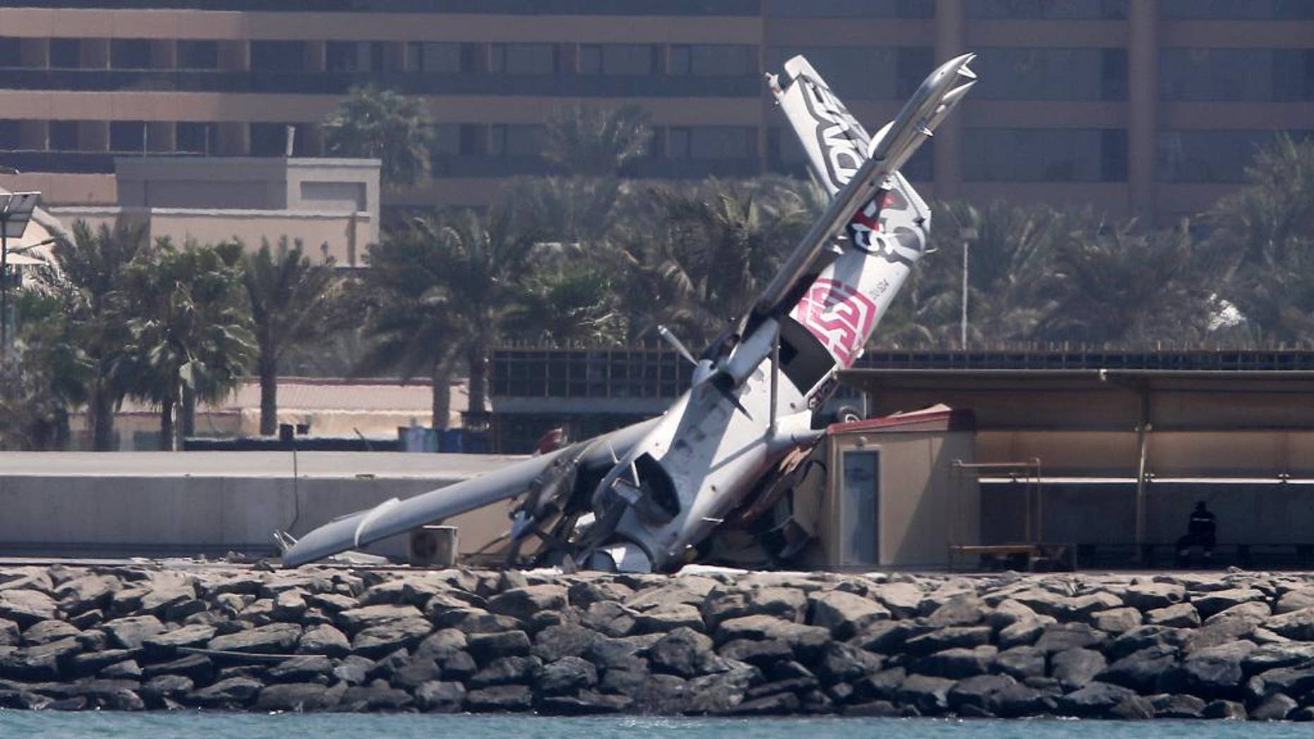 An aircraft belonging to a Dubai skydiving company is seen after crashing off the runway Friday, Oct. 2, 2015, in Dubai, United Arab Emirates. (AP Photo/Kamran Jebreili)