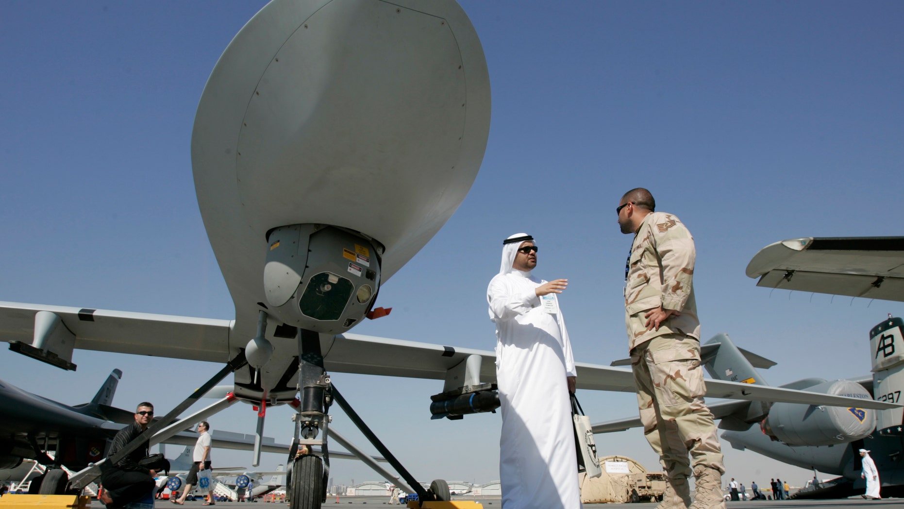 Nov. 12, 2007 - FILE photo of an Emarati visitor asks a U.S. military representative questions, as they stand next to an MQ-1 Predator spy plane, during the 2nd day of the 10th Dubai Airshow, at the Dubai airport, United Arab Emirates.