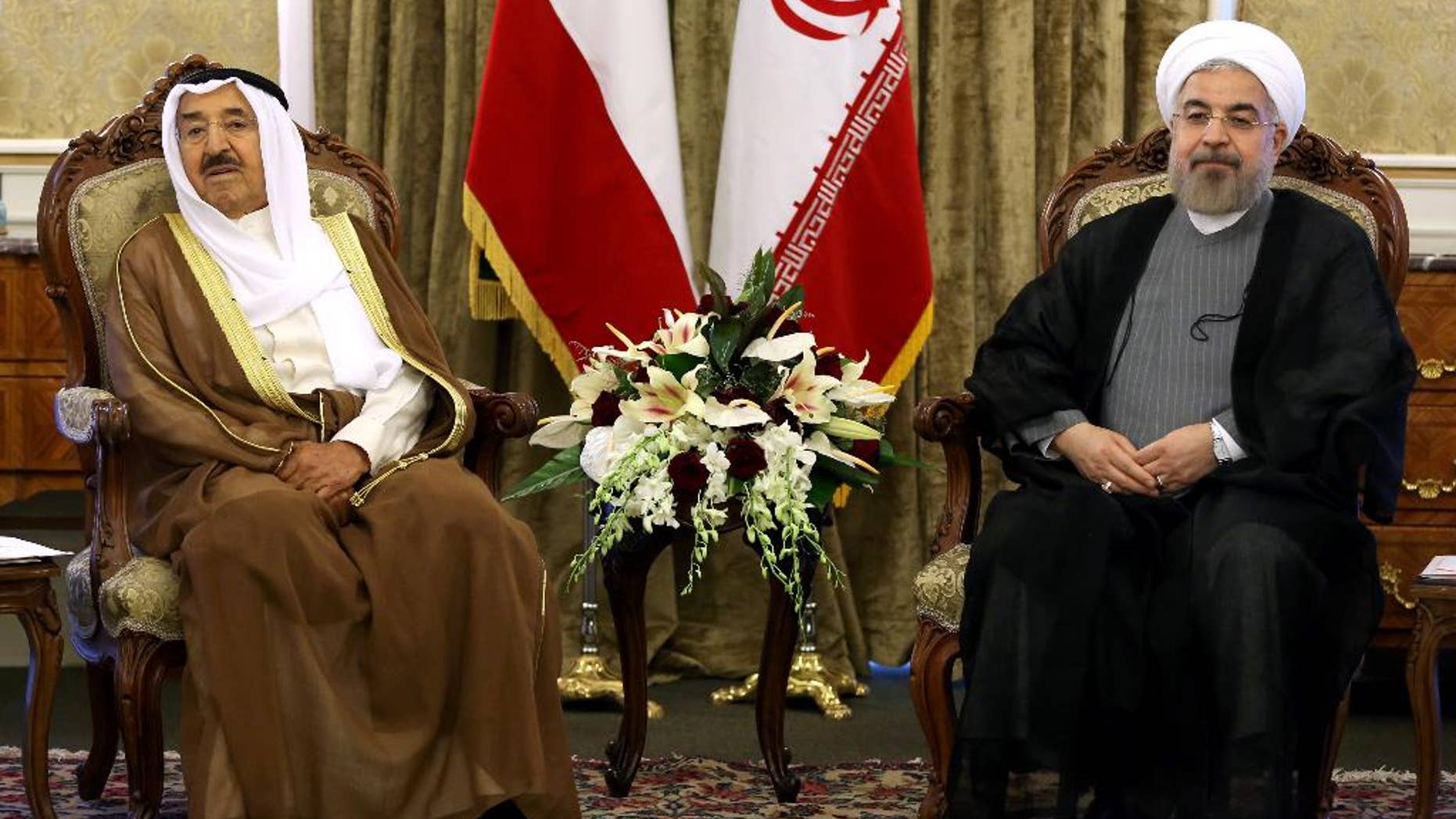 Kuwait's emir Sheik Sabah Al Ahmed Al Sabah, right, and Iranian President Hassan Rouhani, left, meet at the Saadabad Palace in Tehran, Iran, Sunday, June 1, 2014. Kuwait's emir has arrived in Iran's capital, Tehran, for his first visit in decades as the Islamic Republic's relations continue to thaw with Gulf nations under moderate President Hassan Rouhani. (AP Photo/Ebrahim Noroozi)